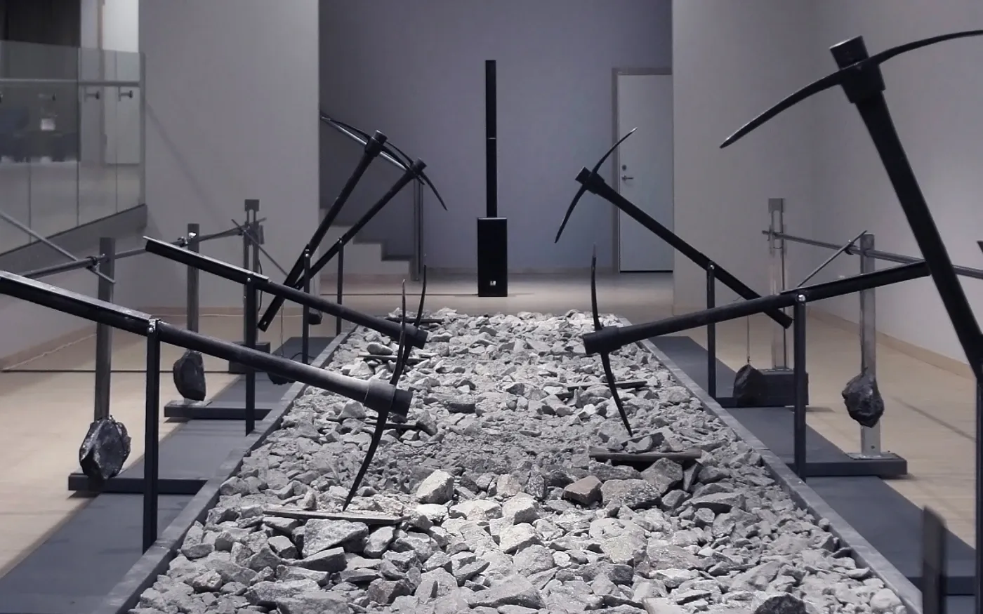 Andreas R Andersson -Installation with gravel bed and metal pickaxe structures, Road of Bones, Piteå Konsthall 2023, 