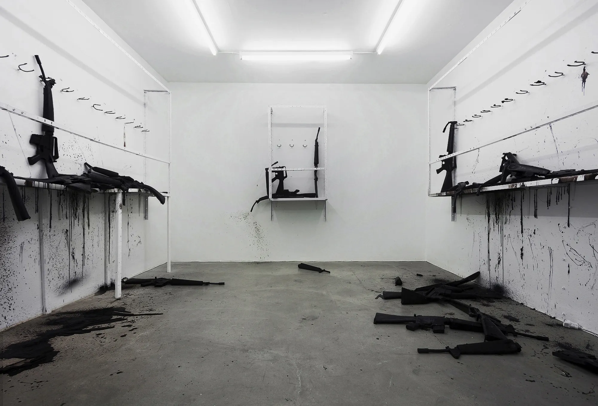 Andreas R Andersson,Installation with broken black rifle forms and splattered surfaces, The Thousand Yard Stare, Gallery Box Gothenburg 2013–2014, Photo by Martin Hultén