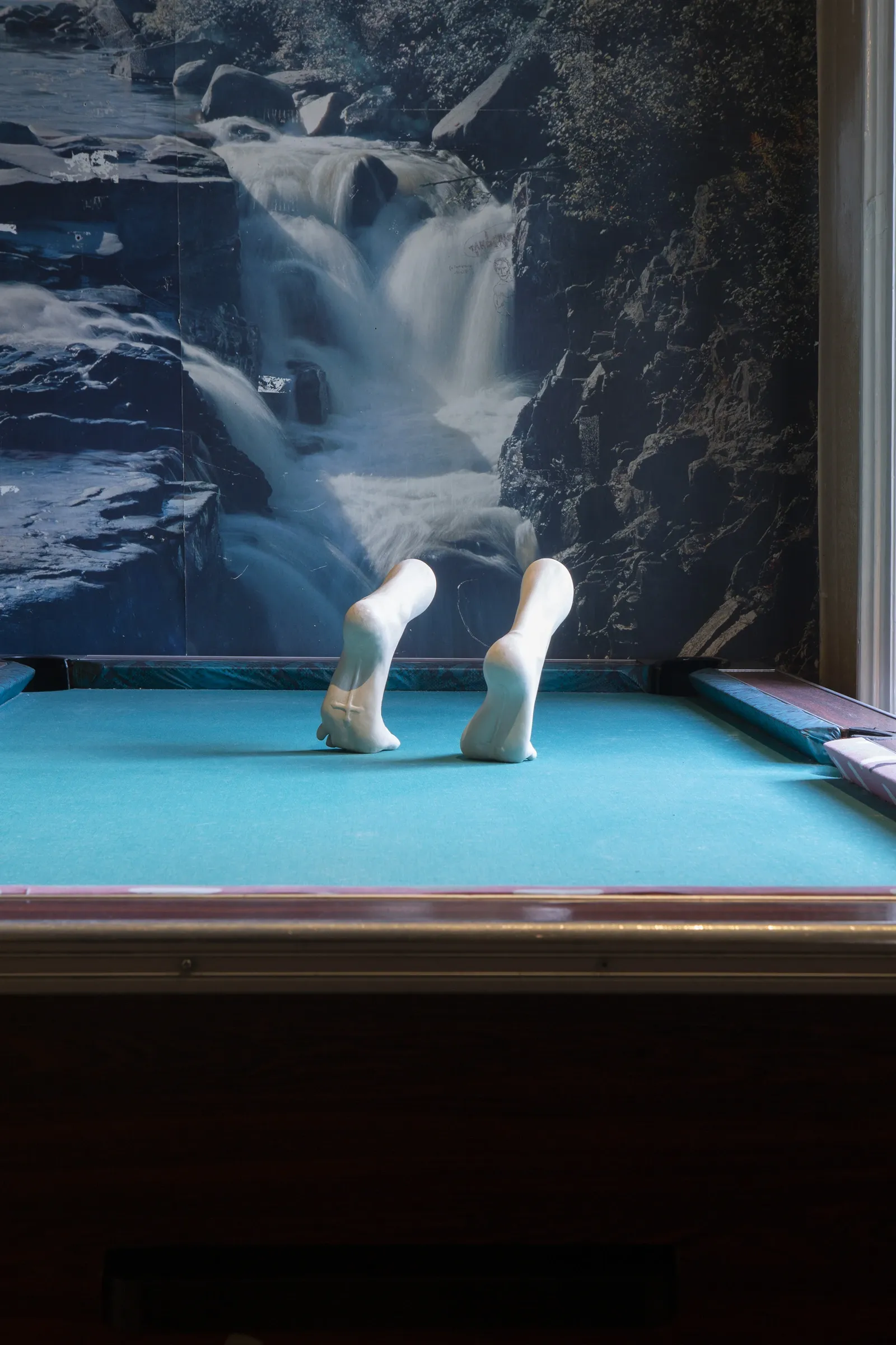 Céline Struger A Blessing and a Burden ceramic sculpture placed on pool table in interior setting