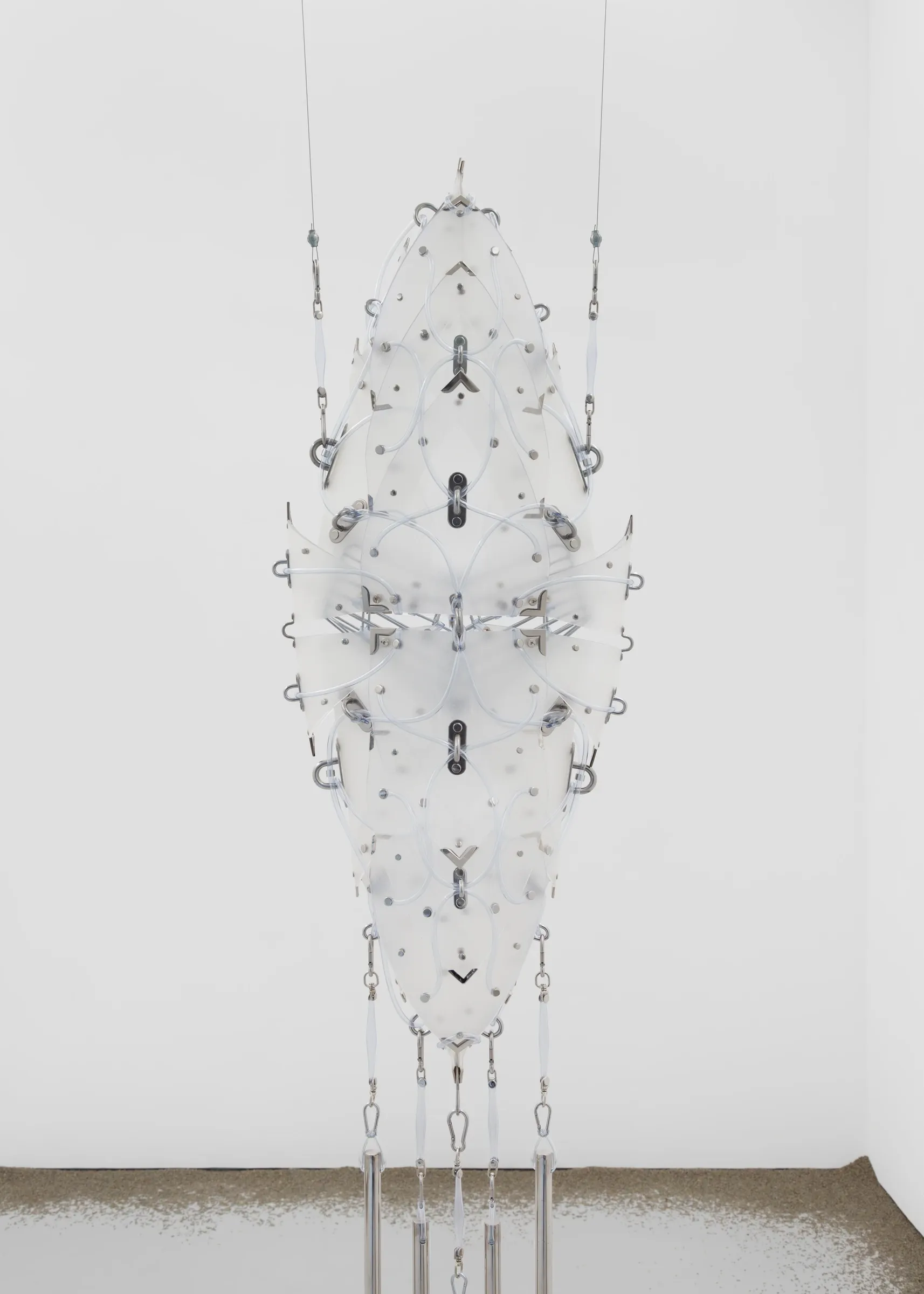 Front view of suspended PVC orthosis sculpture with steel and tubing, Floryan Varennes Pixie at Xxijra Hii London