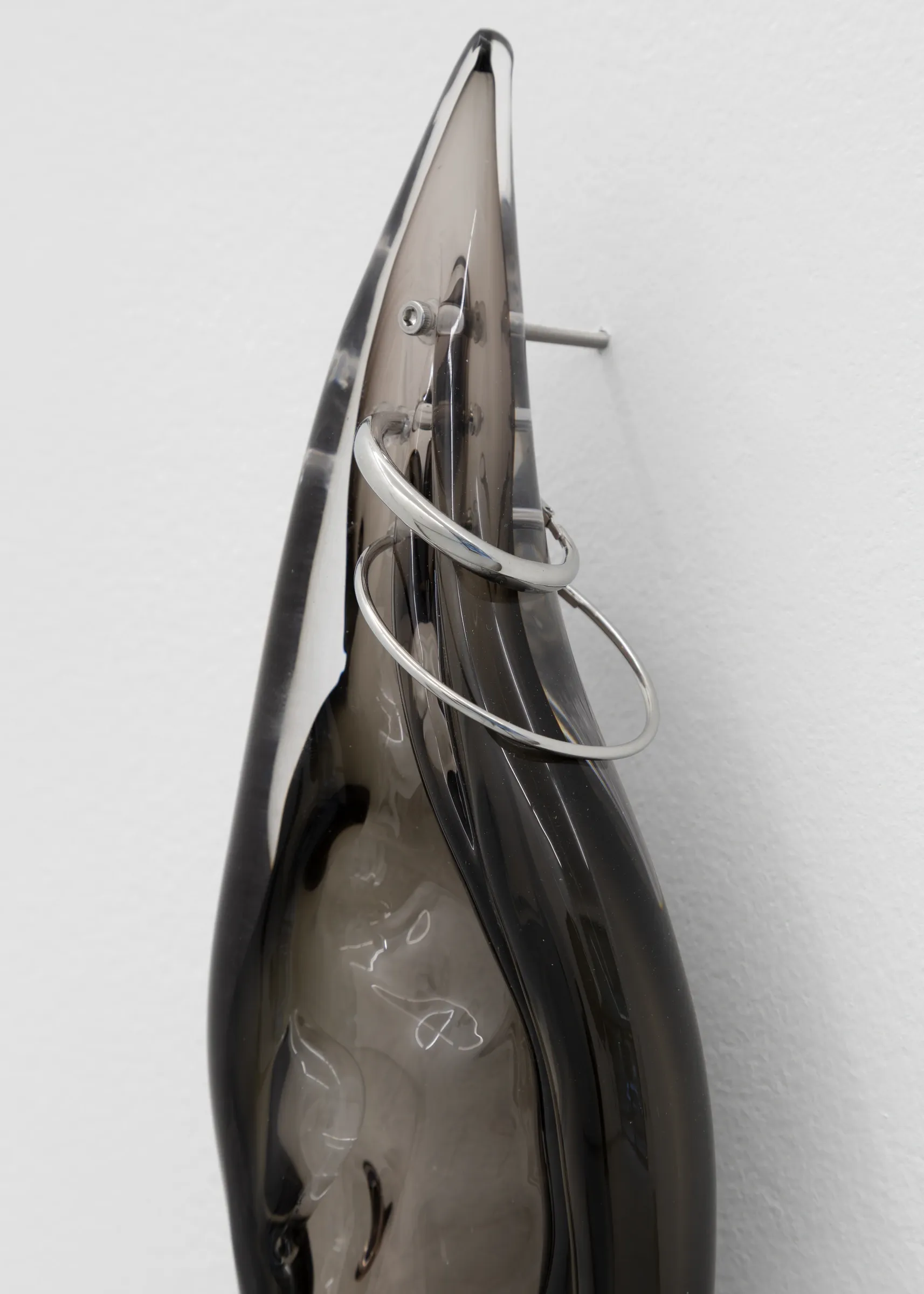 Close-up of glass ear sculpture with stainless steel rings and fittings, Floryan Varennes Spike series at Xxijra Hii London