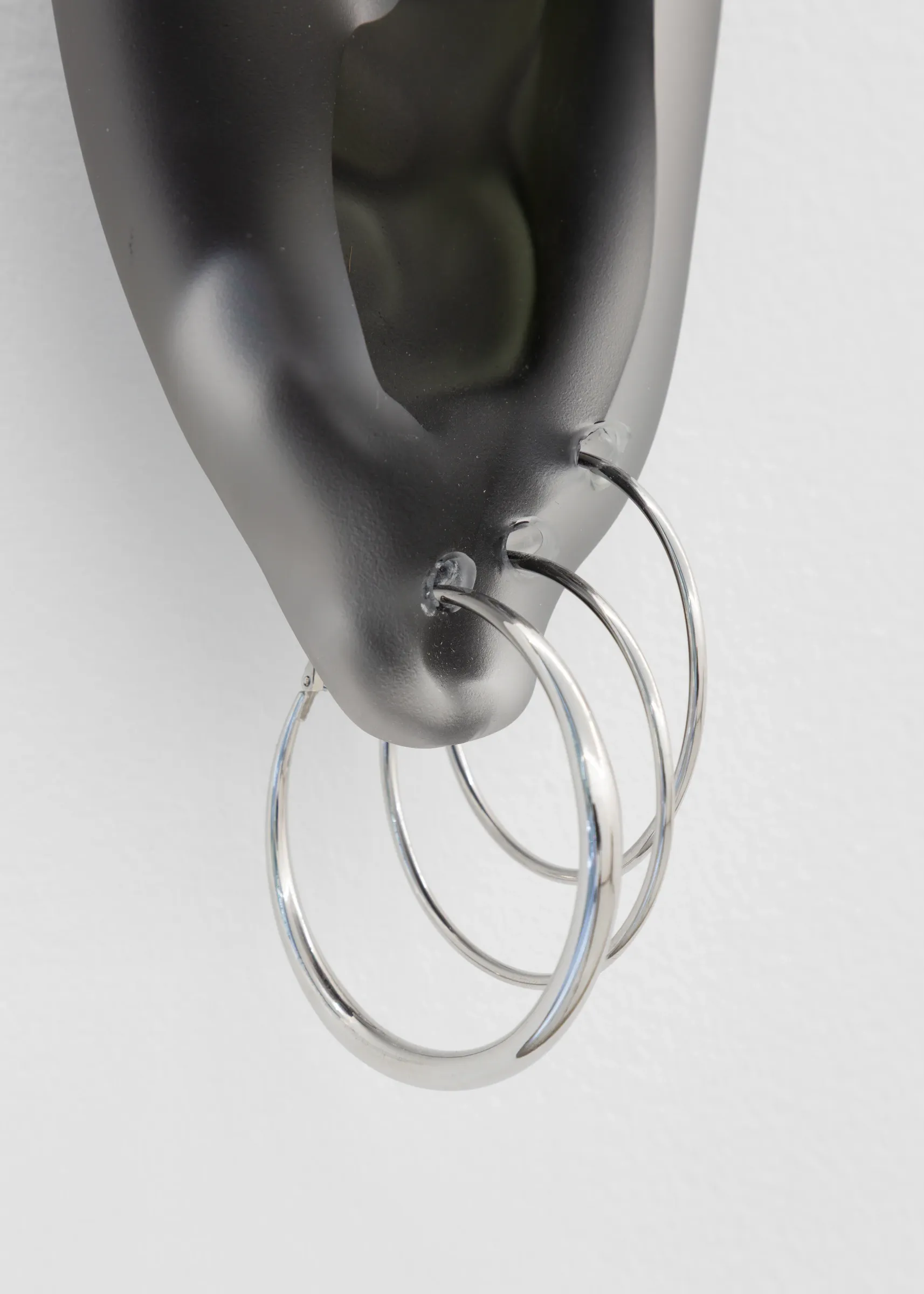 Close-up of glass sculpture pierced with stainless steel rings, Spike series by Floryan Varennes at Xxijra Hii London