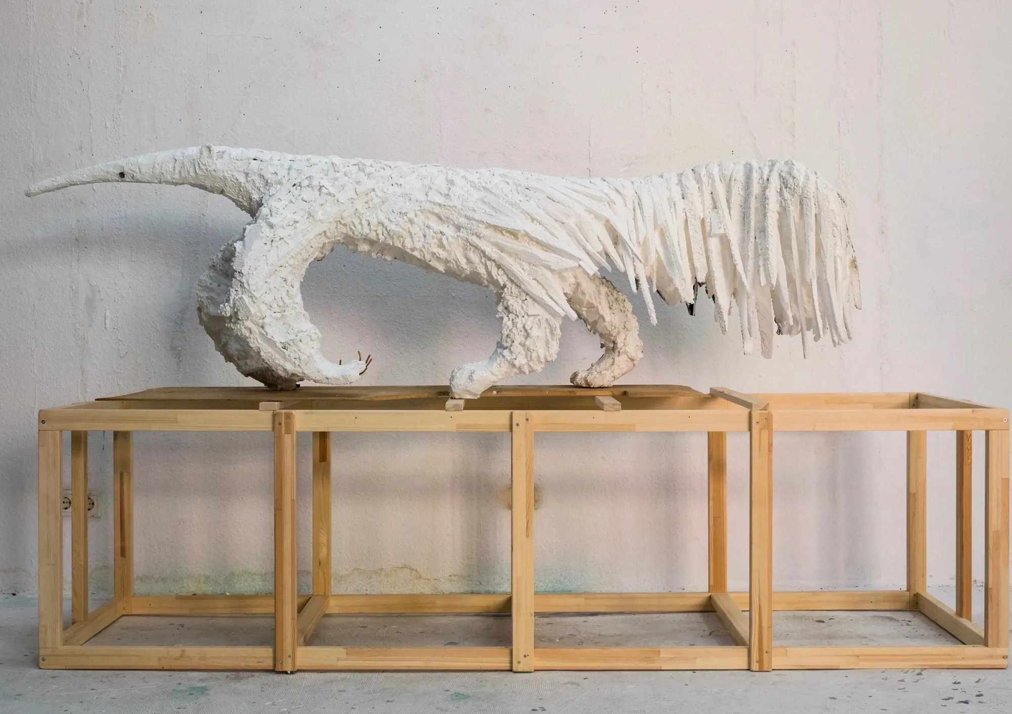 White anteater sculpture made of styrofoam and steel on wooden base, Lin May Saeed