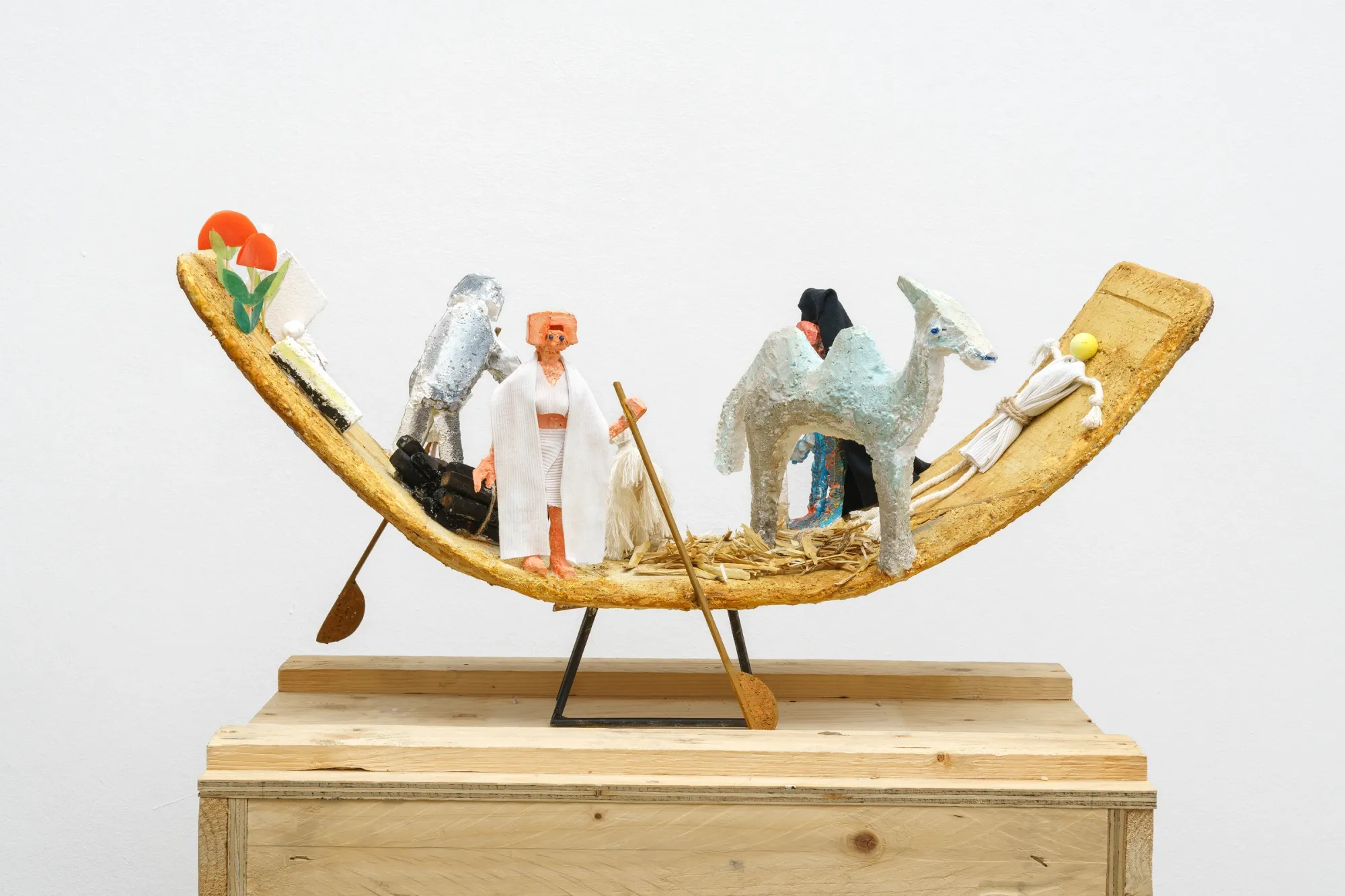 Lin May Saeed Barque 2021 mixed media sculpture showing a small boat with human and animal figures including a camel in a fragile floating scene