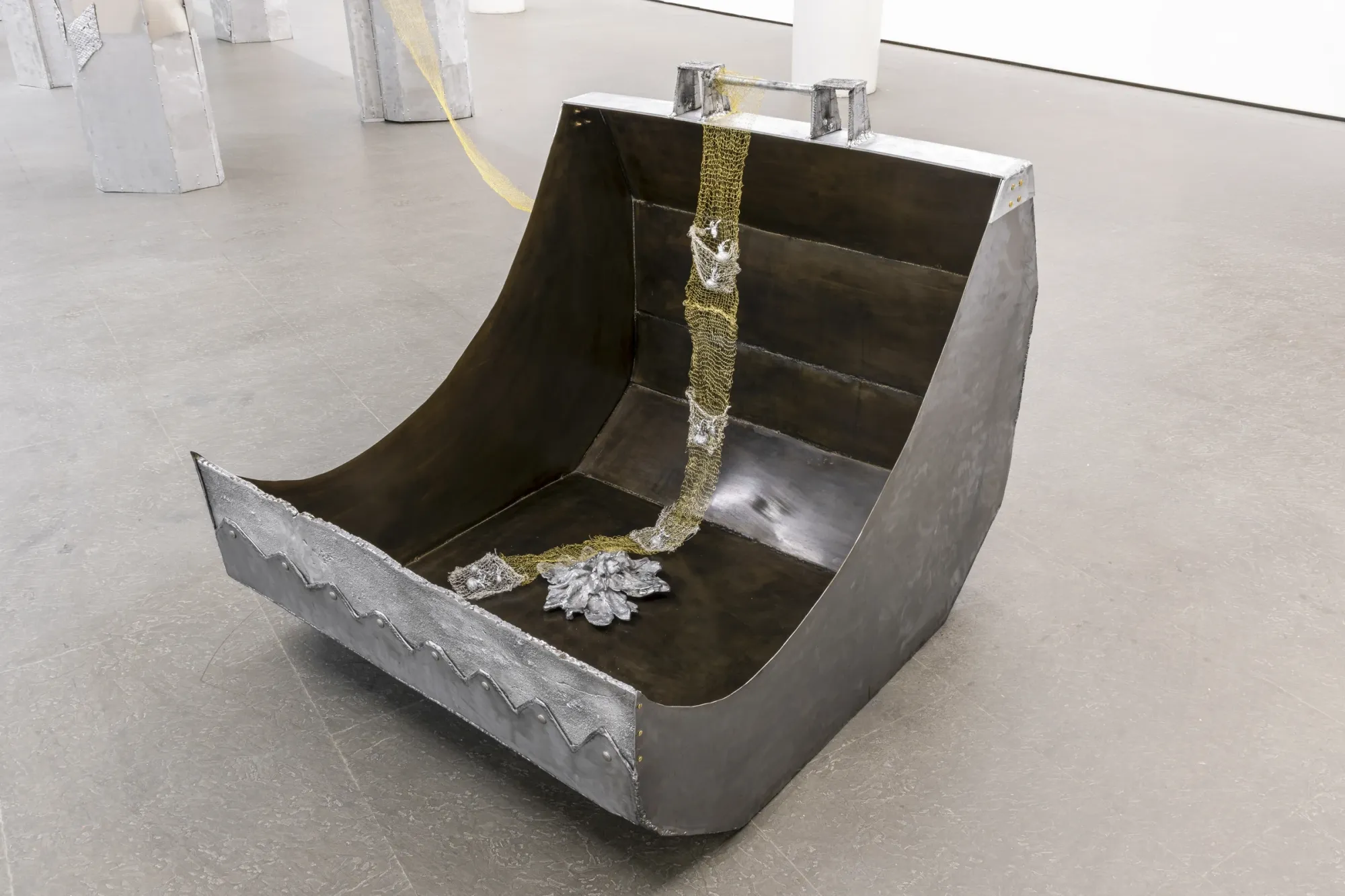 Maija Fox Hard Shoulders detail showing excavator bucket form with woven metal wire and cast aluminium plant elements at Sinne Helsinki