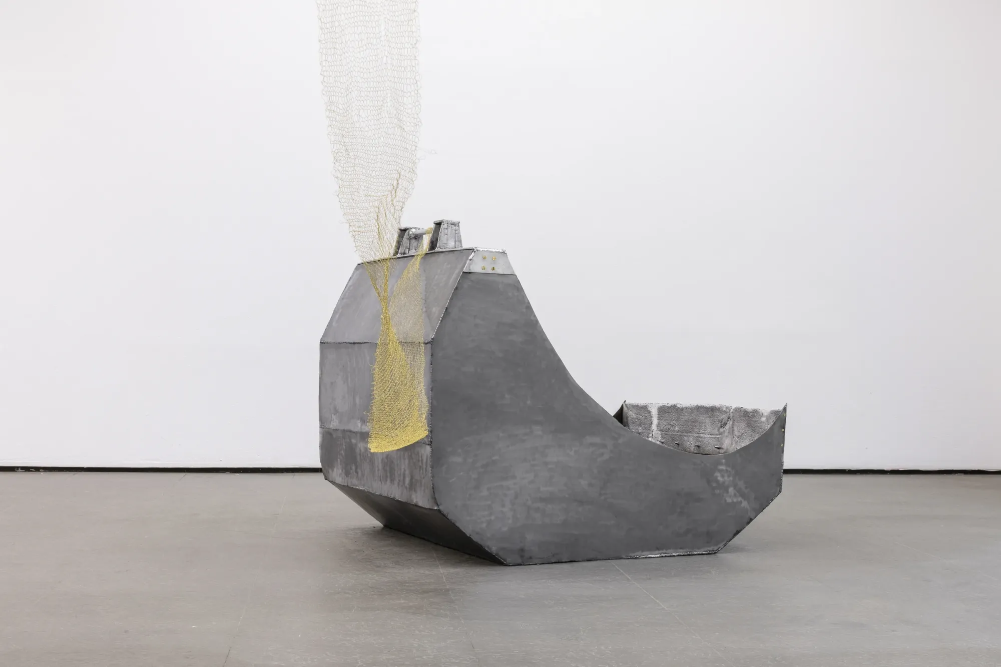 Maija Fox Hard Shoulders detail with curved metal structure and woven wire element emerging from cast aluminium surface at Sinne Helsinki