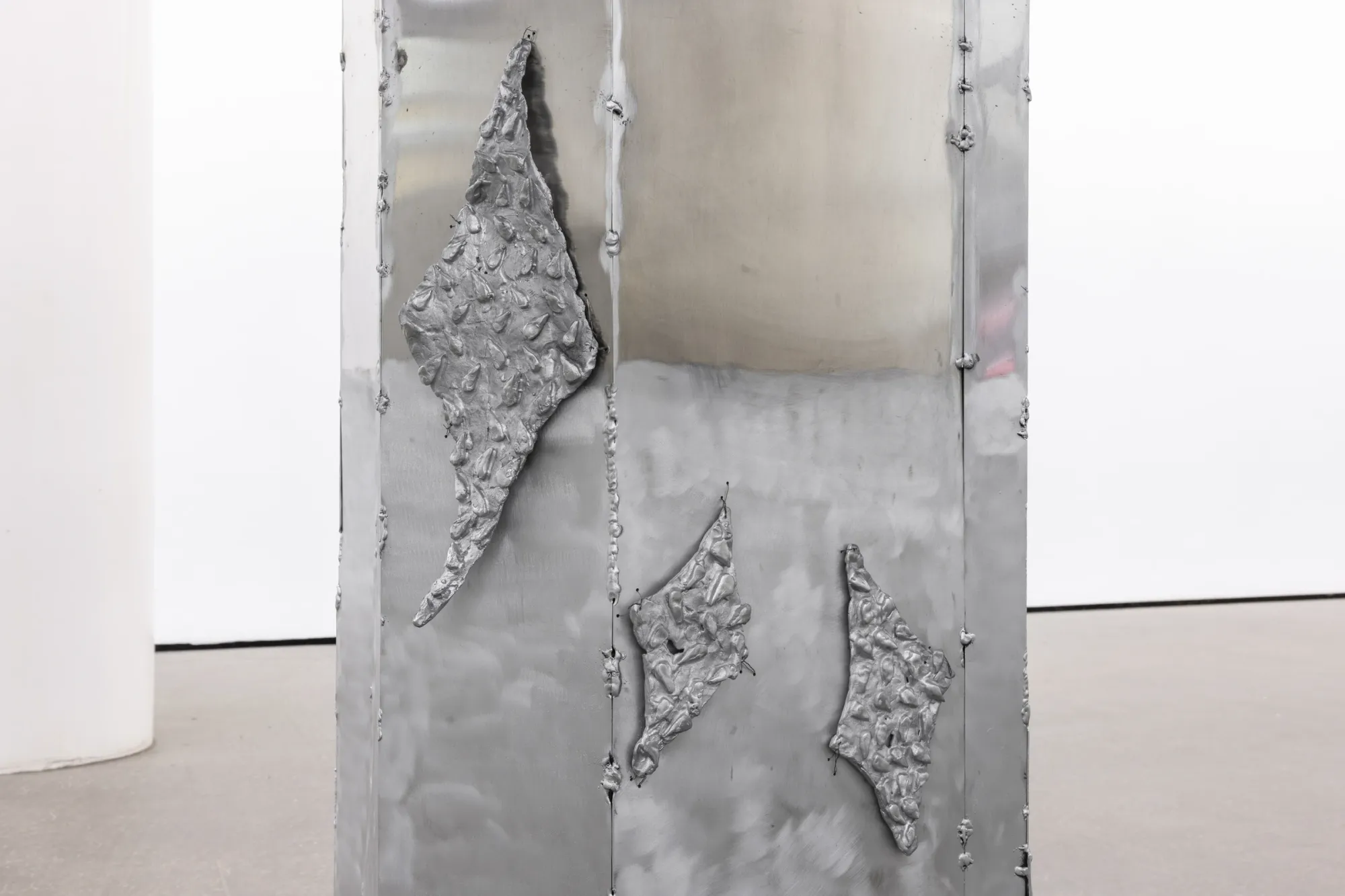 Maija Fox Hard Shoulders detail showing cast aluminium organic panels attached to metal column surface within installation at Sinne Helsinki