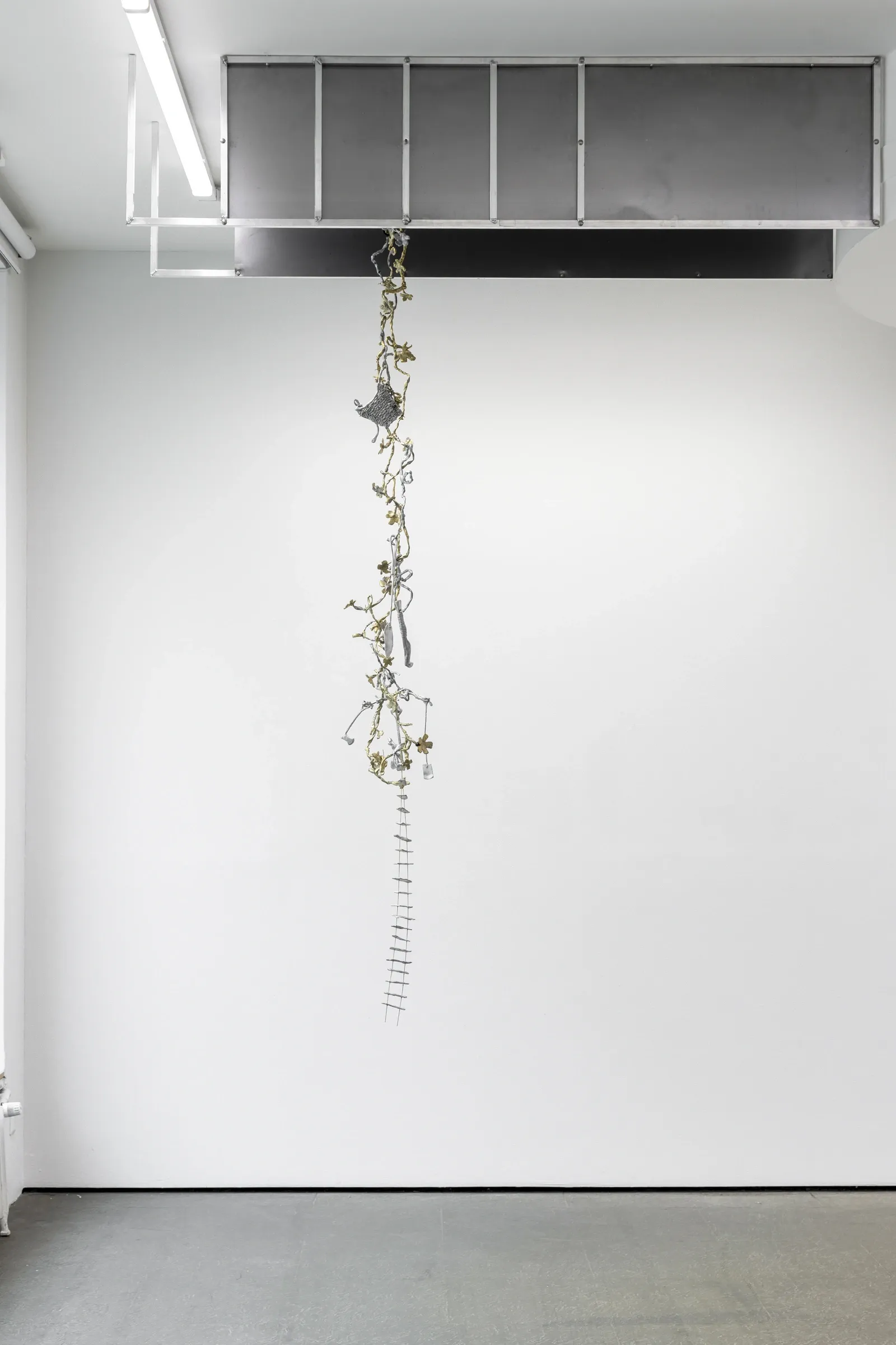 Maija Fox Hard Shoulders installation detail showing suspended sculptural chain of cast aluminium and brass elements hanging from ceiling structure