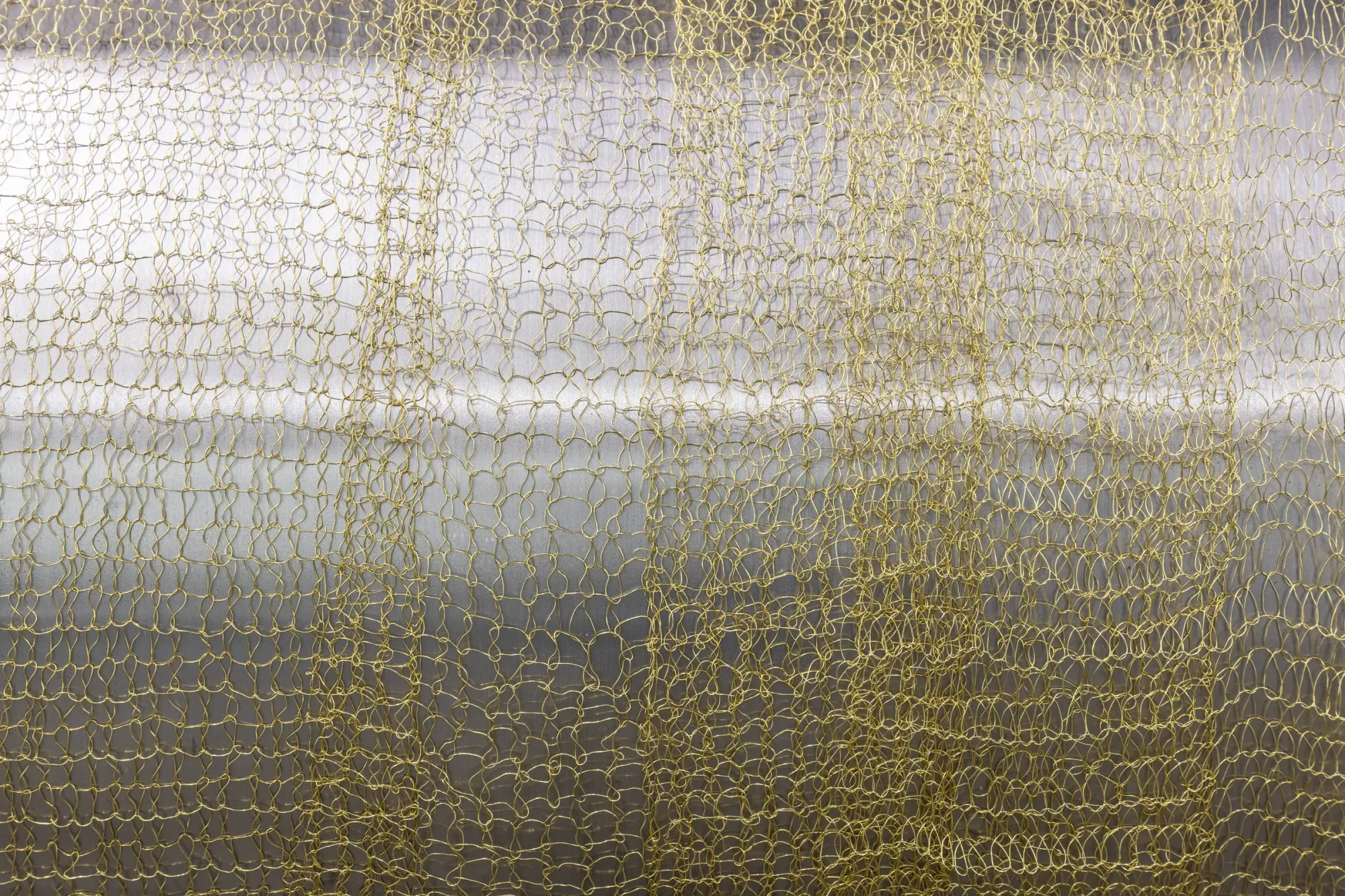 Maija Fox Hard Shoulders detail showing woven metal wire textile structure layered over metallic surface