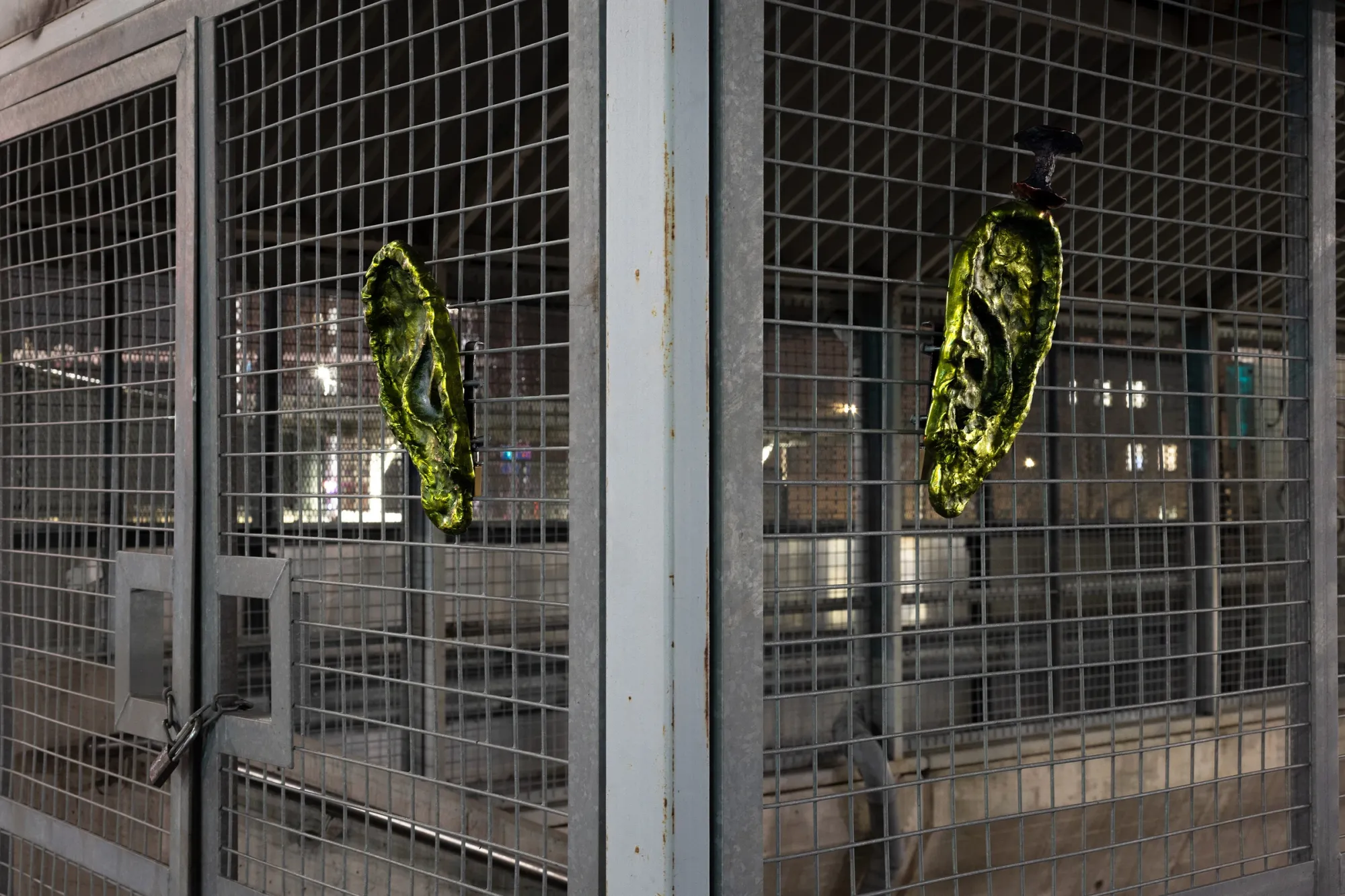Detail of "Whose head has the noseyest ears?" (2026) by Matti Sumari, anodized aluminium sculpture installed on metal grid outside SIC Helsinki, part of the exhibition Worker Ant After Work