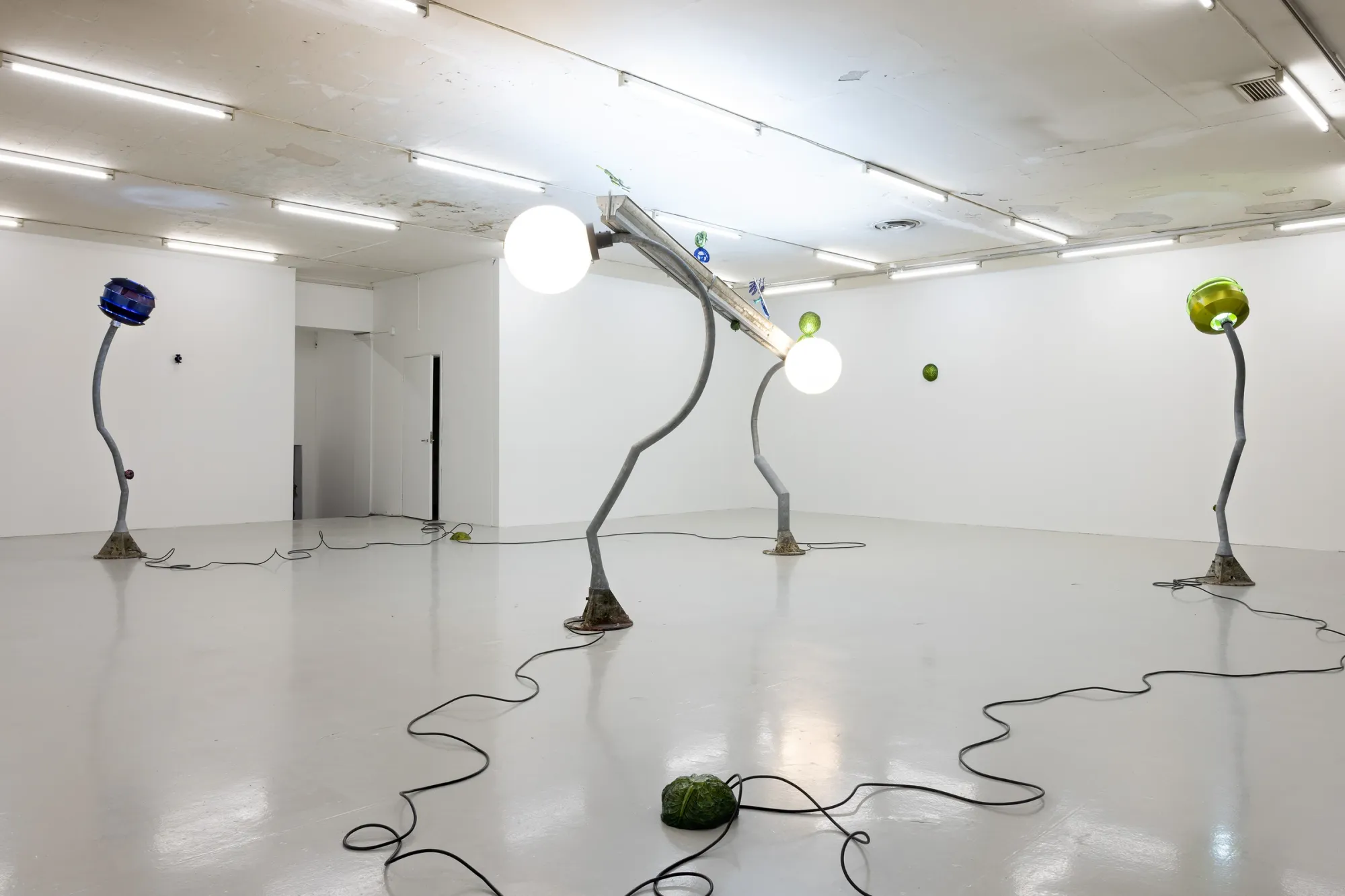 Installation view of Worker Ant After Work (2026) by Matti Sumari at SIC Helsinki with sculptural street lights and anodized aluminium elements