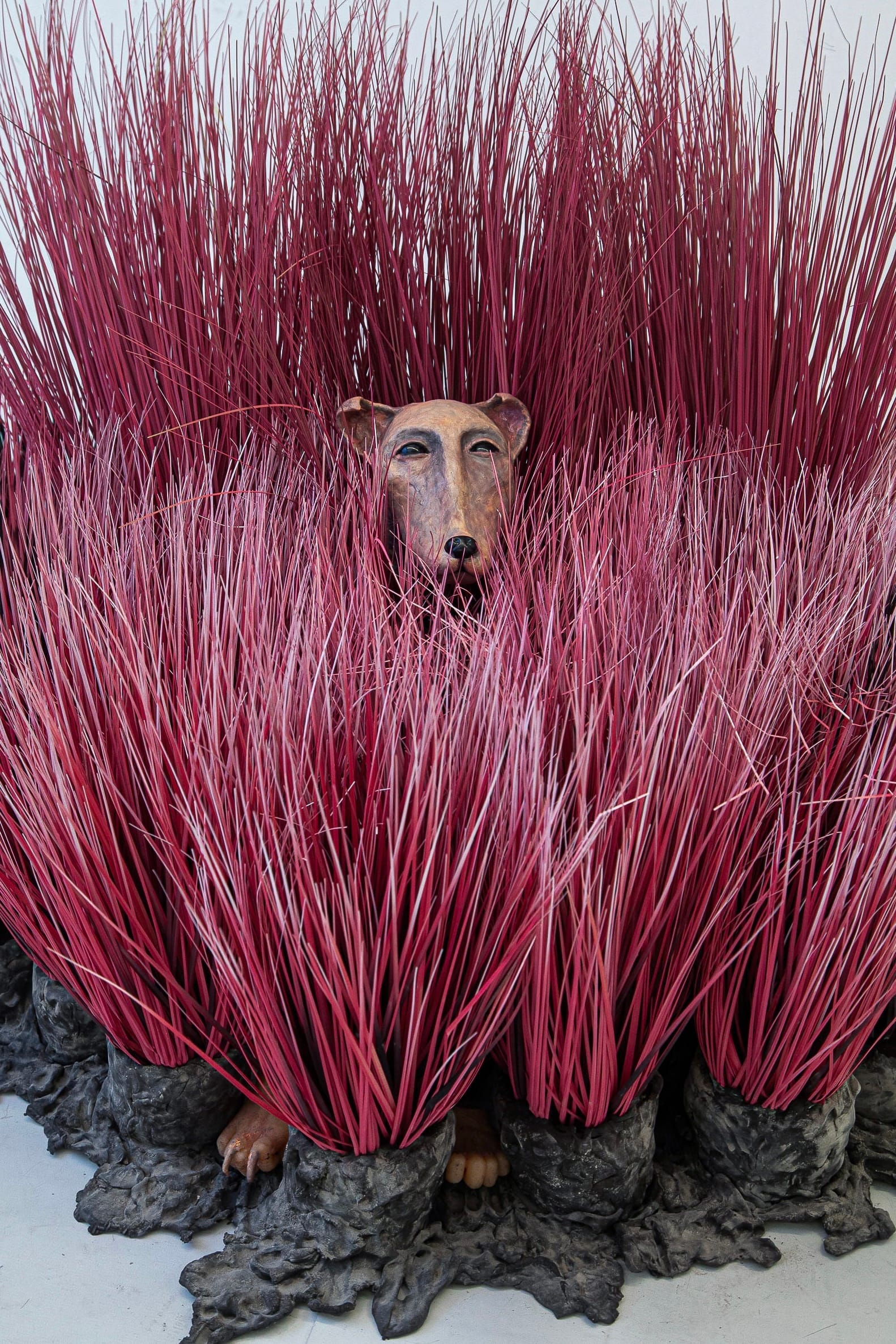 Shirley Fu Dog 2024 sculpture with hybrid animal form emerging from dense red brush like elements mixed media installation in studio