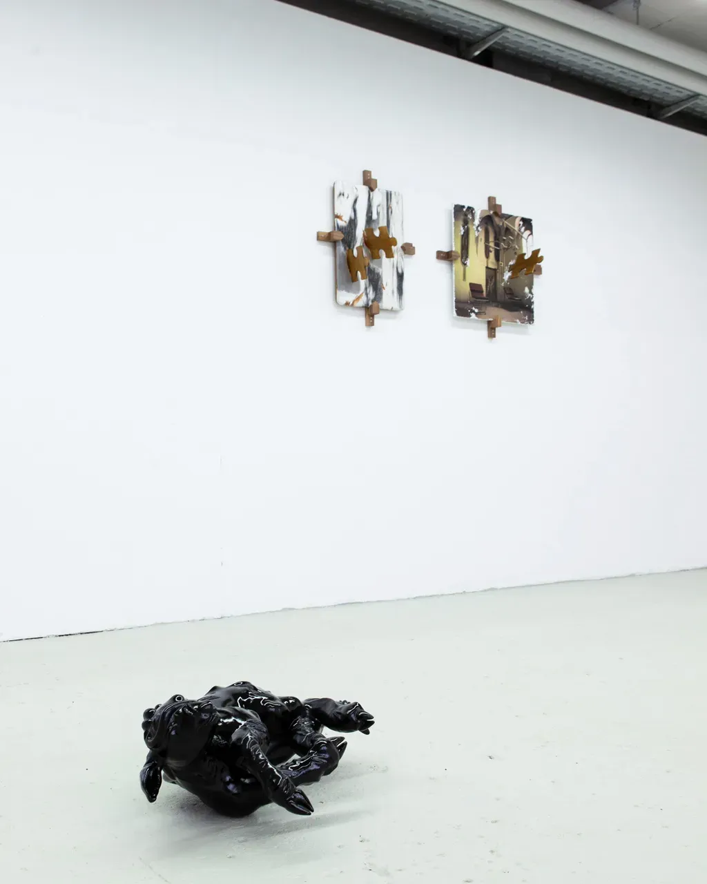 Vivienne Sun Liminality installation with black organic sculpture on floor and wall-mounted photographic works in institutional space