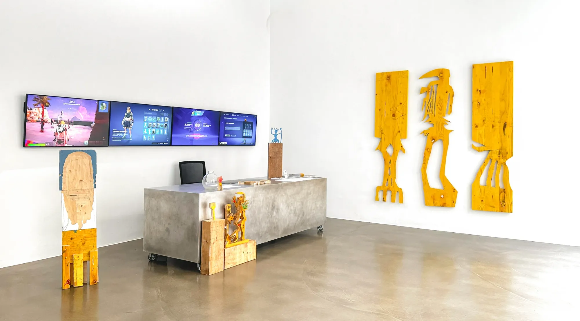 Ernst Koslitsch, installation view second room with video game screens, metal desk, and large yellow timber panels, Cosmic Trigger – Respawn, Bildraum 07, Vienna, 2026