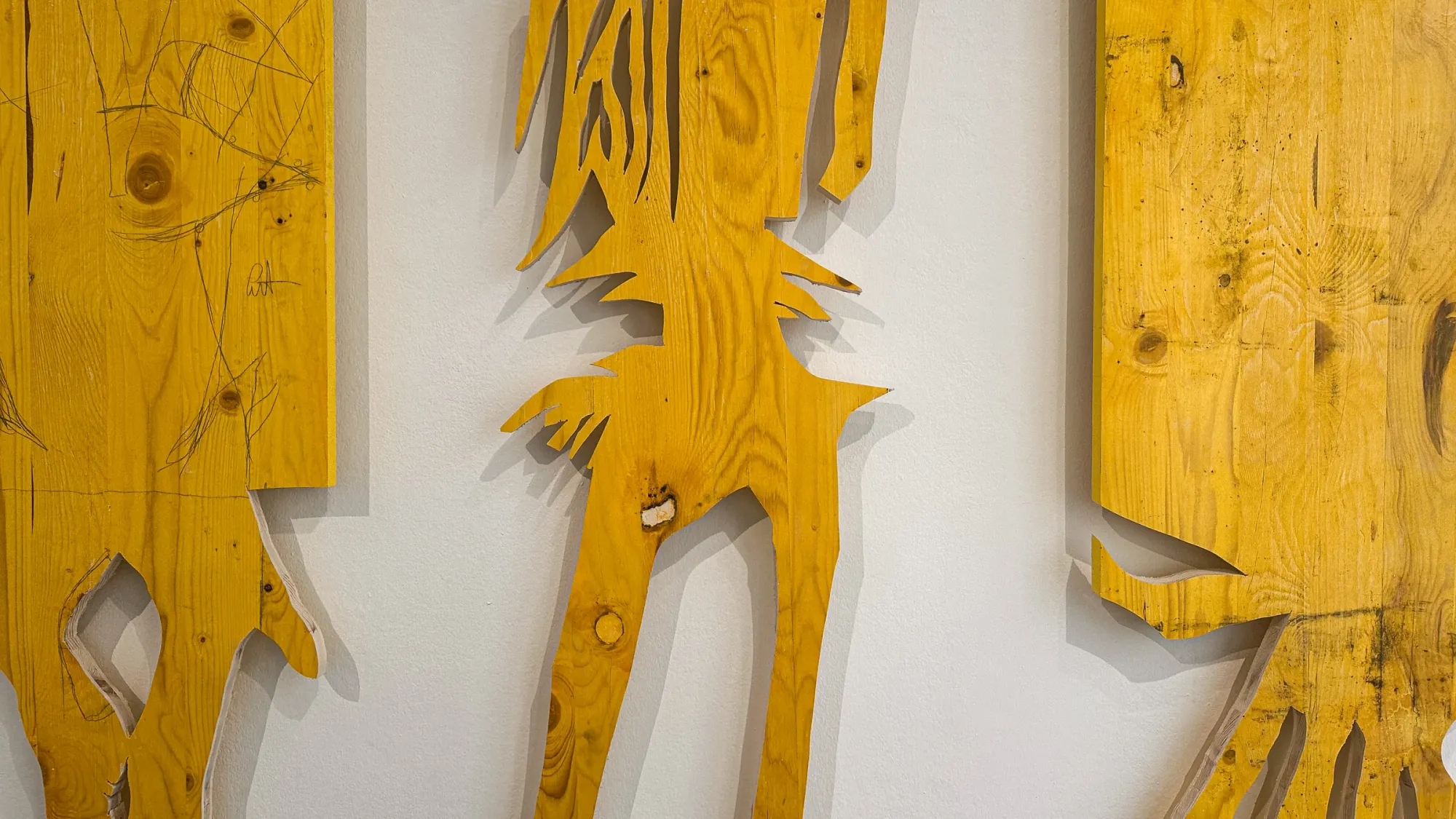 Ernst Koslitsch, detail of large yellow formwork timber panels cut into figural silhouettes, Cosmic Trigger – Respawn, Bildraum 07, Vienna, 2026
