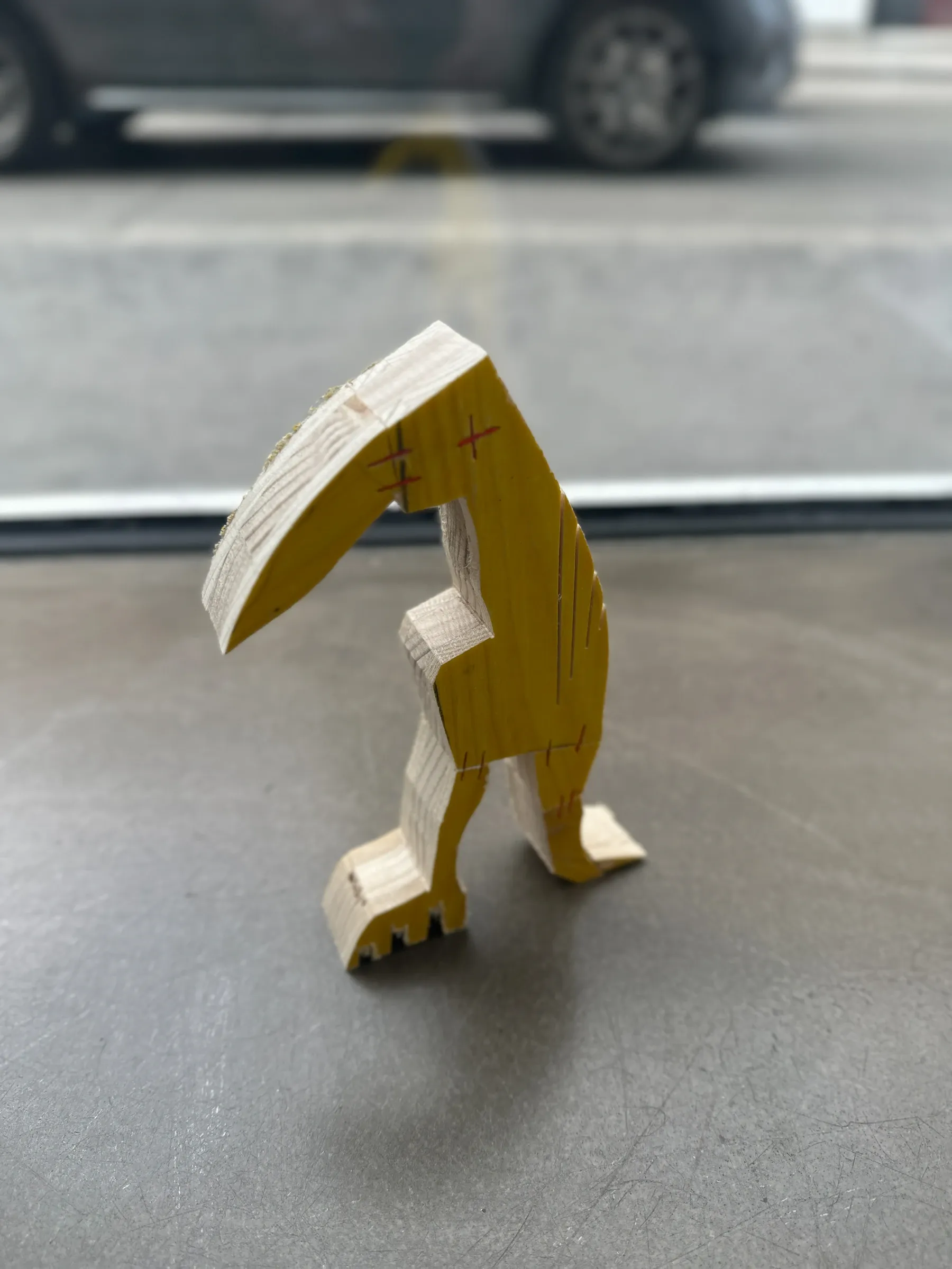 Ernst Koslitsch, small bird-figure formwork timber sculpture at gallery window, Cosmic Trigger – Respawn, Bildraum 07, Vienna, 2026