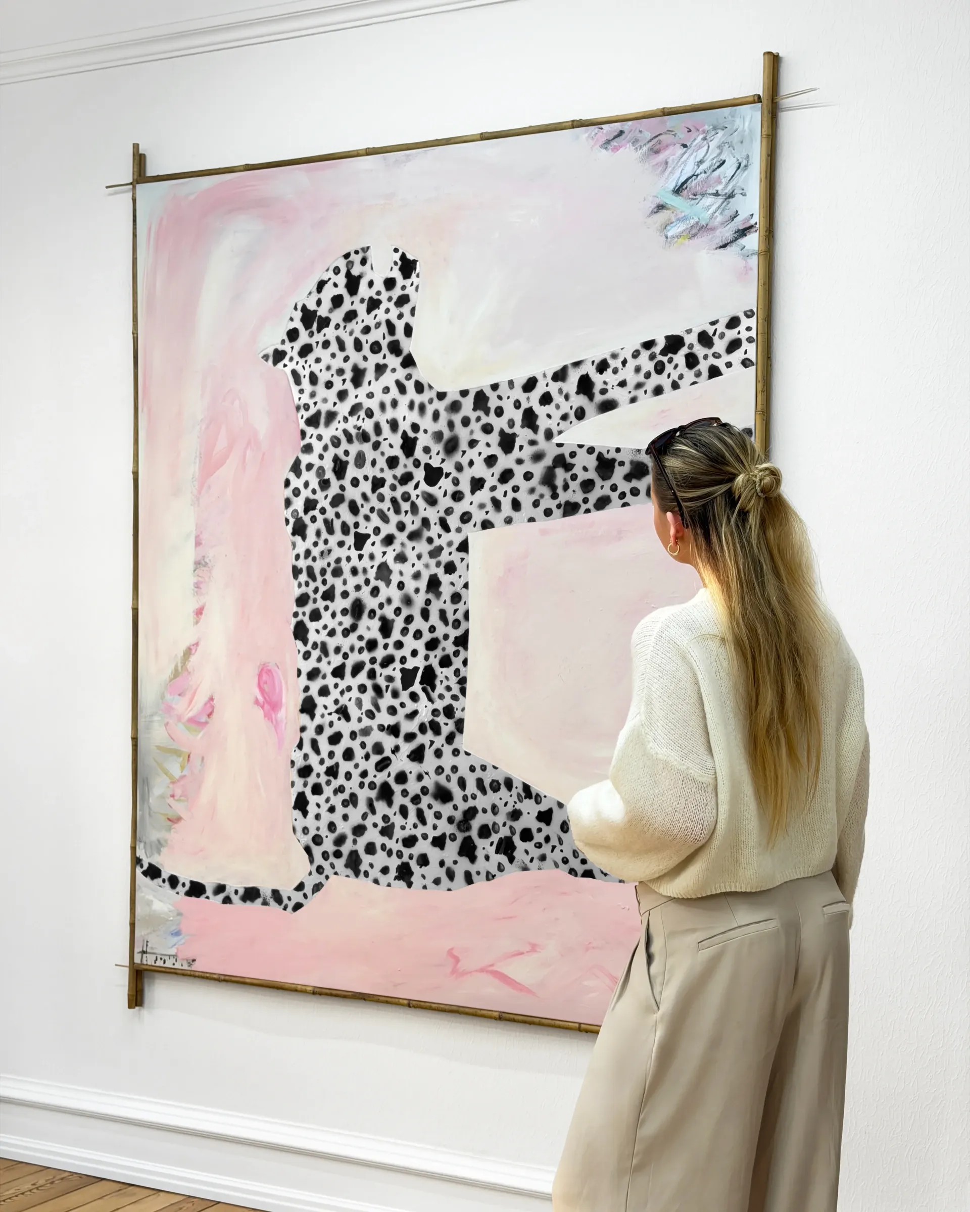 Gallery Fusion: Visitor looking at Dino Cama large-scale painting with spotted figure silhouette on pink background, Grihodda,