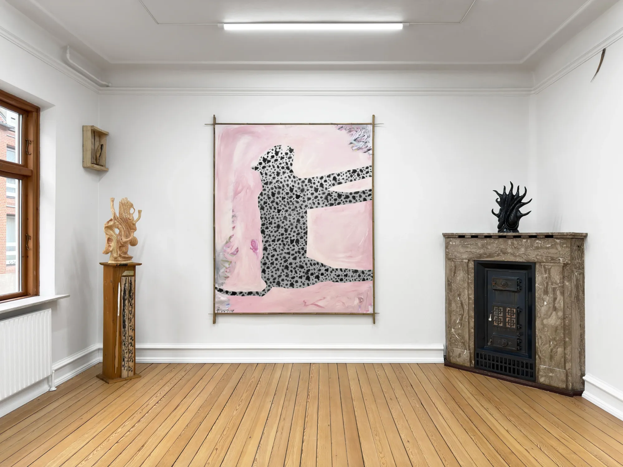 Installation view of Grihodda with Dino Cama spotted figure painting, Rune Lambrecht ceramic sculpture on pedestal and black glazed ceramic on fireplace, GalleryFusion