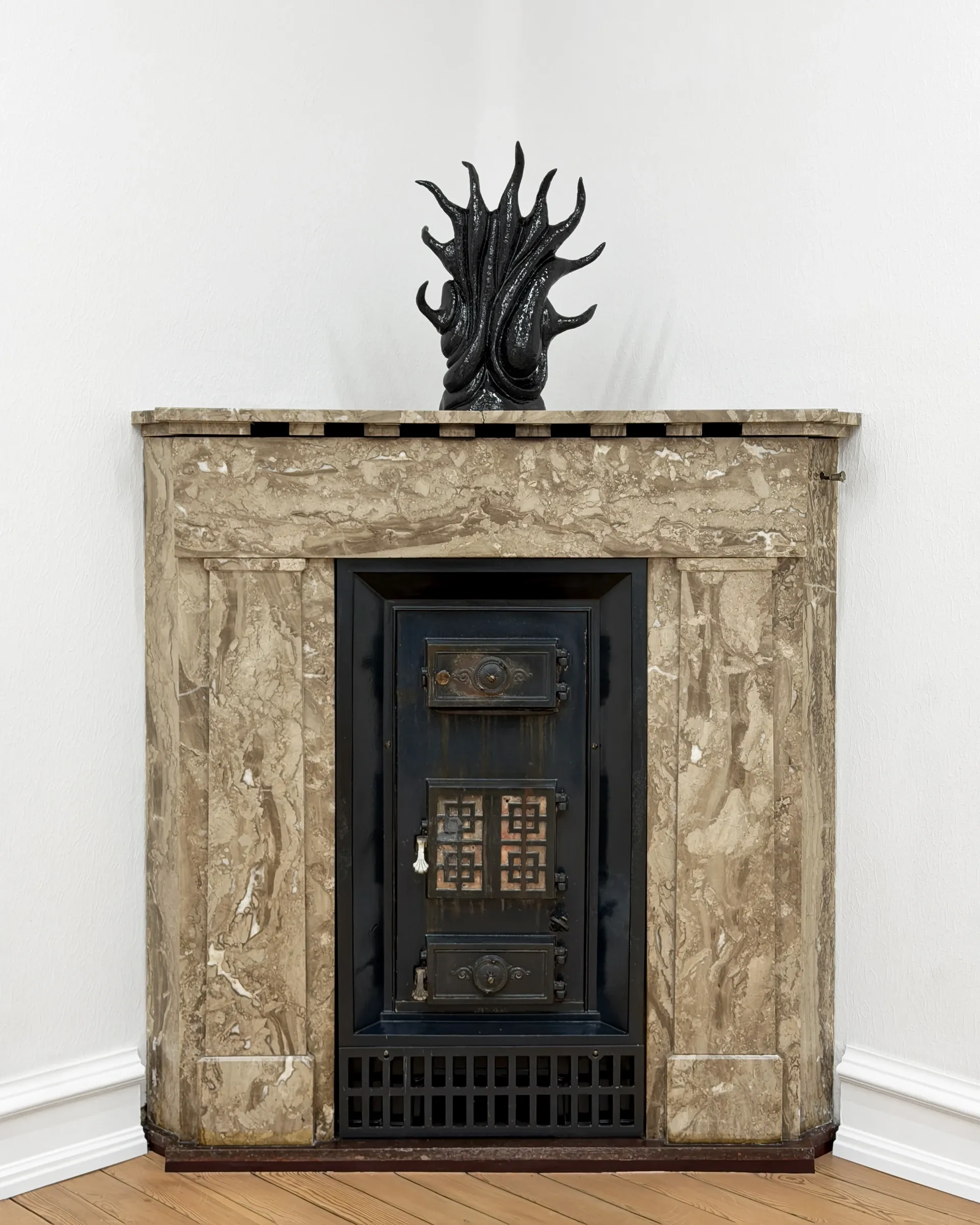 Gallery Fusion: Rune Lambrecht black glazed ceramic flame sculpture placed on marble fireplace, Grihodda,