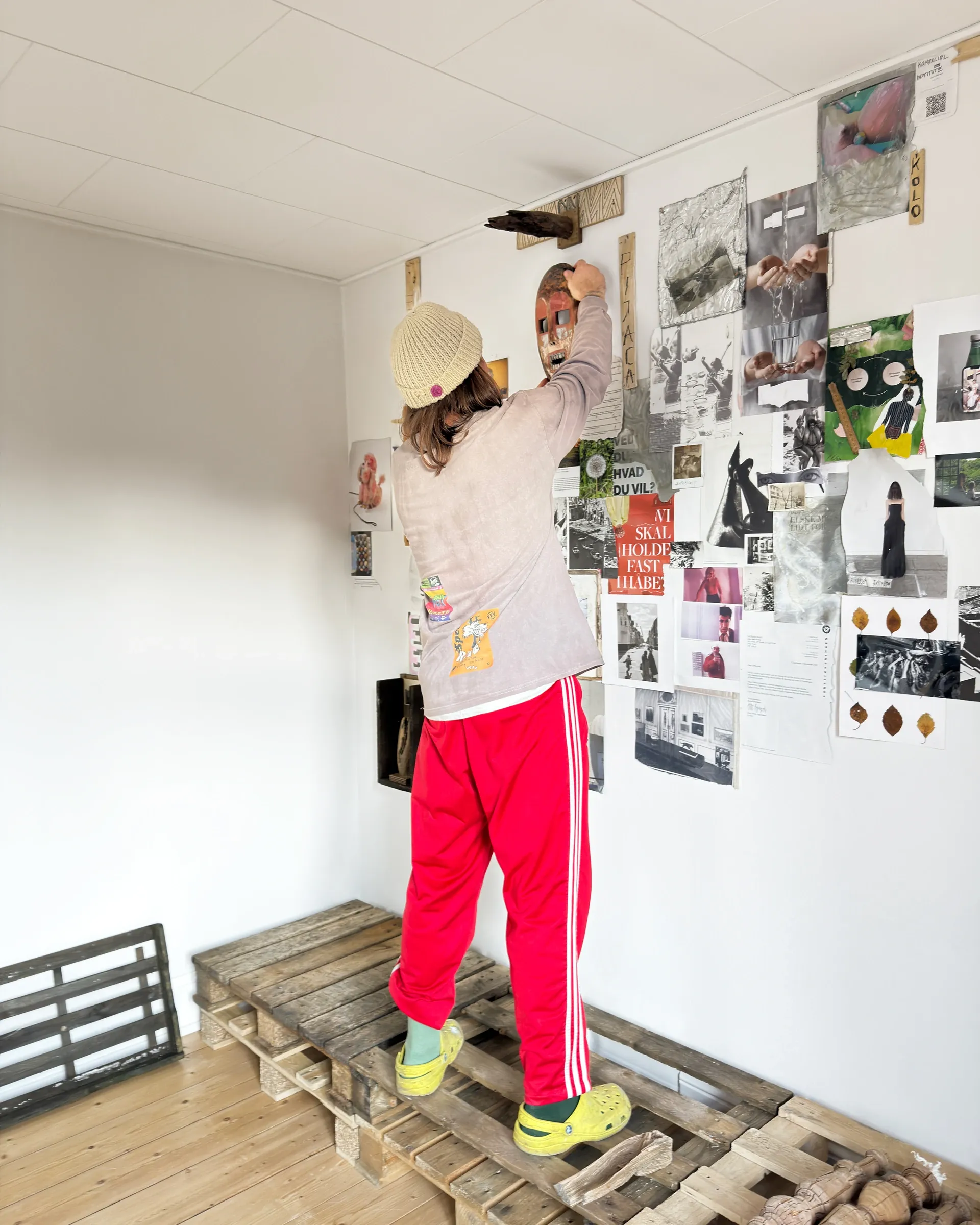 Rune Lambrecht installing collage wall during exhibition setup at Gallery Fusion: , Grihodda