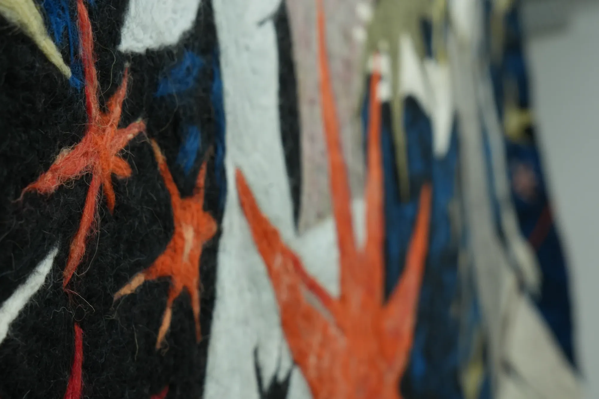 Gvantsa Jishkariani, Catalogue of galaxies n1, 2026 — detail of suspended felt sculpture with spiked star forms in red and beige tones, highlighting wool texture and layered surface; Georgian and Italian wool felt; The Why Not Gallery at Fabrika Project Space, Tbilisi.