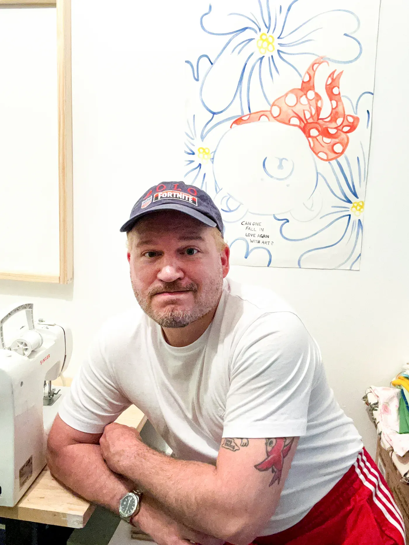 Daniel Ferstl portrait in his Vienna studio, Fortnite cap, sewing machine, work in progress