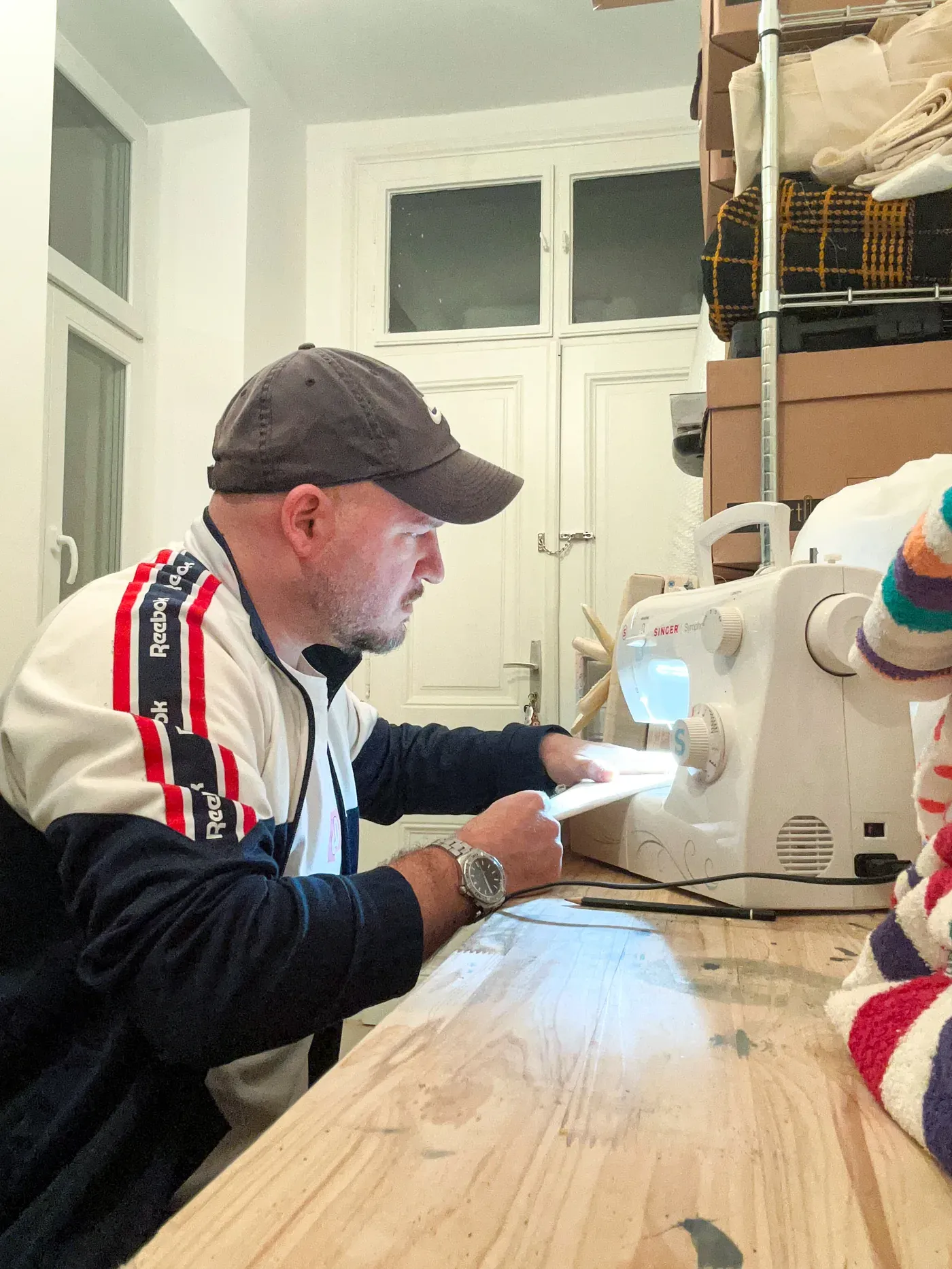 Daniel Ferstl sewing at his Singer sewing machine in his Vienna studio