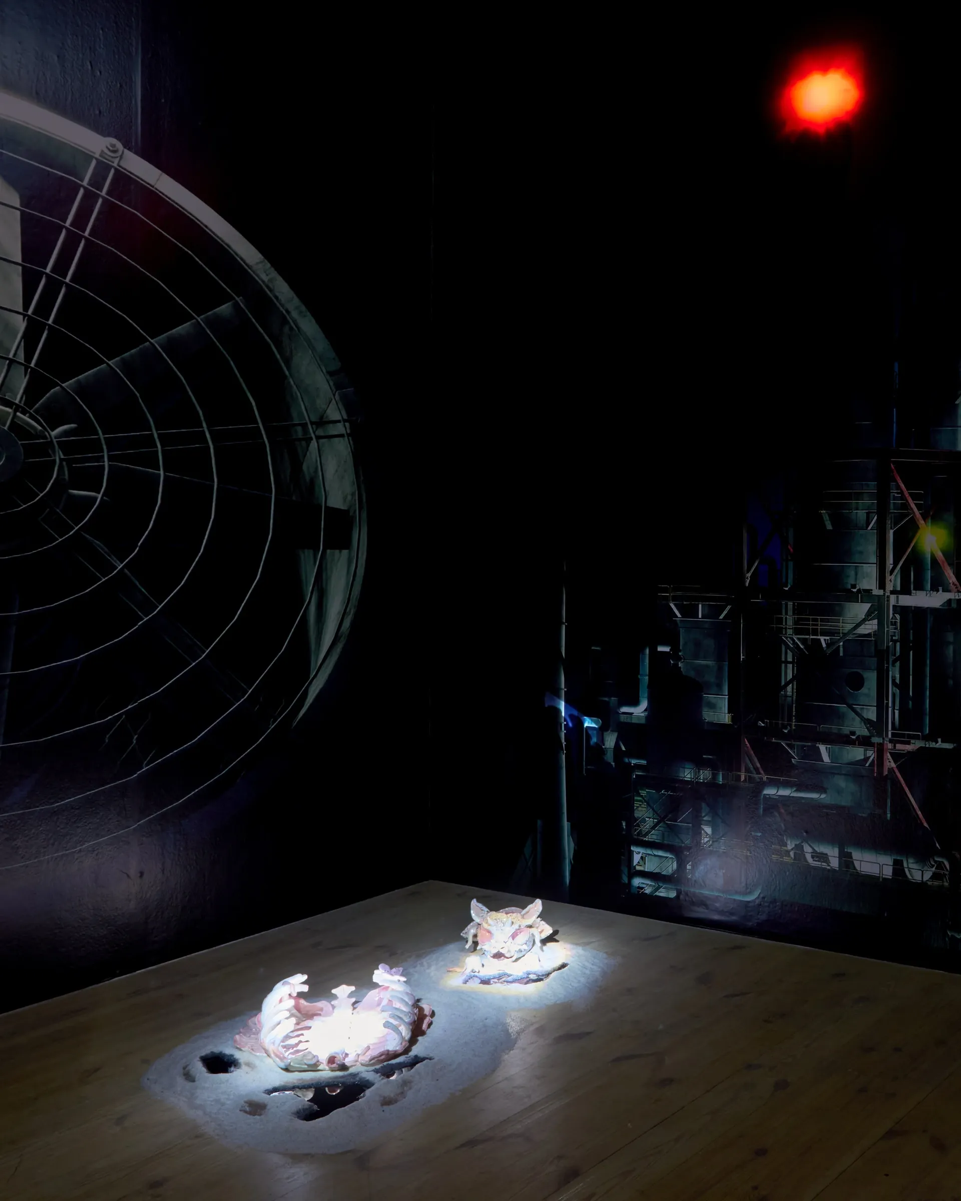 Anna Engelhardt and Tina Bxtq, Bleed Through, Galerie 35M2, Prague, 2026, room view with two ceramic objects spotted on floor and large fan detail above