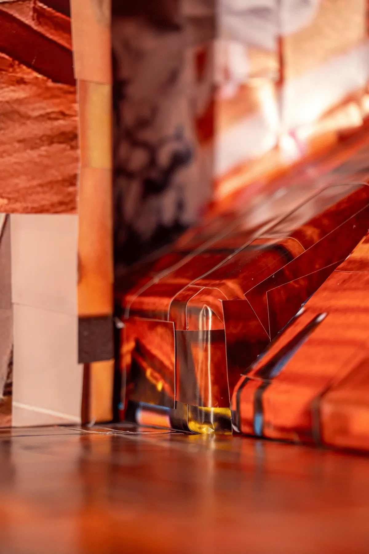 Gwon Osang, SCULPTURE CENTER 4/4, PS ROY, Seoul, 2026, extreme close-up of resin-coated panel edge at floor level, amber light