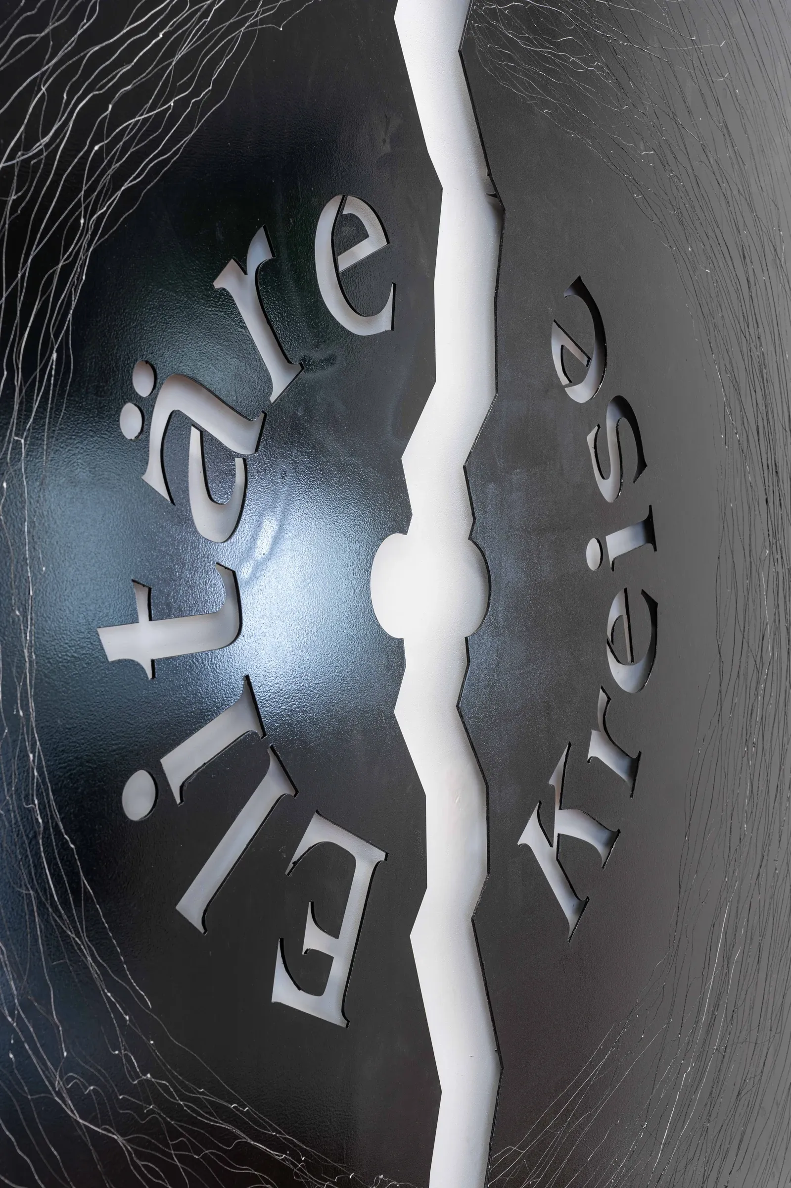 Joschua Yesni Arnaut, Elitäre Kreise, Galerie 3AP, Frankfurt, 2026, close-up of crack running through vinyl record surface with metallic lettering