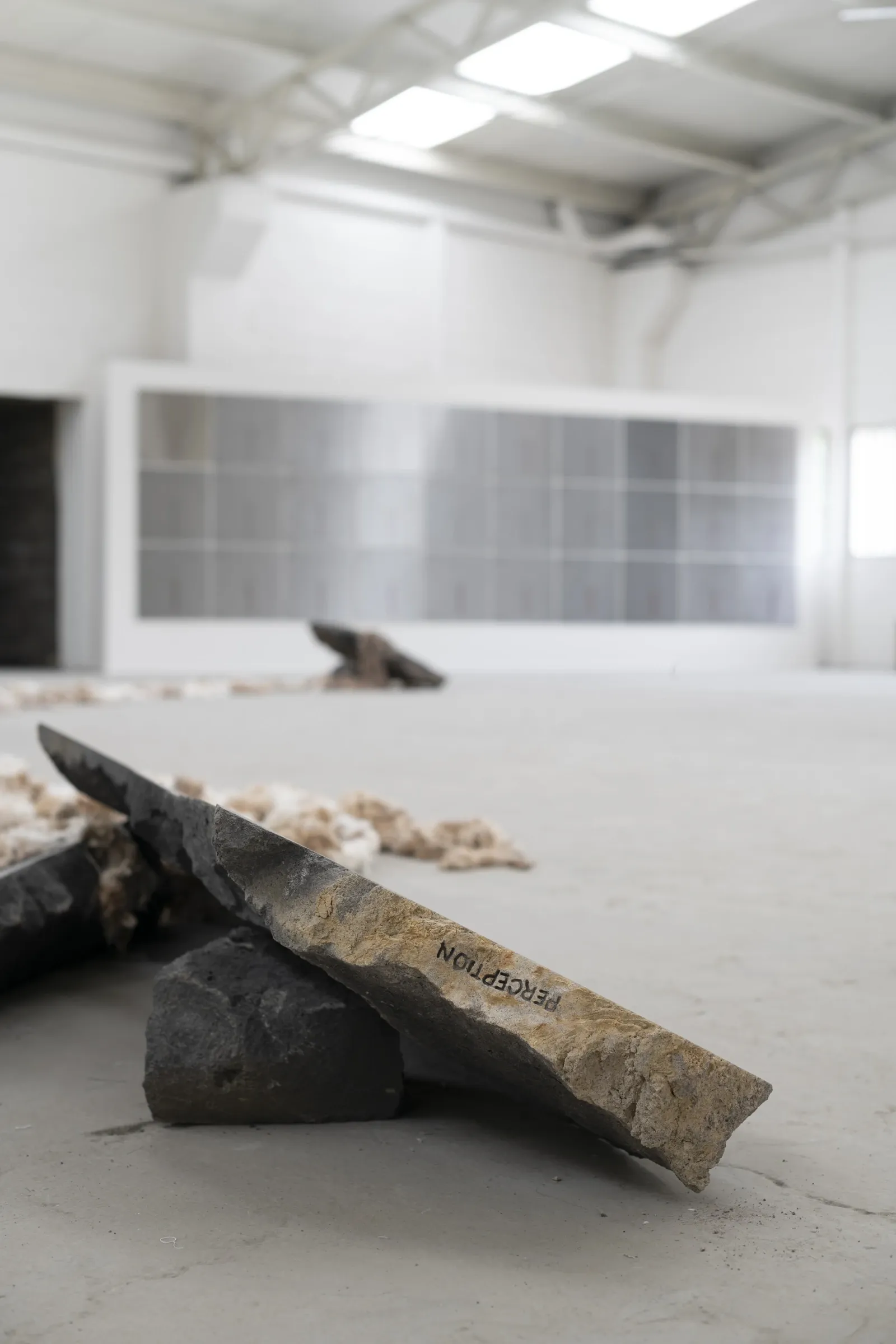 KiefferWoodtli, AXES, Alvarez Chida, Mexico City, 2026, stone slab with PERCEPTION text balanced on volcanic stone, heliosPlates in background