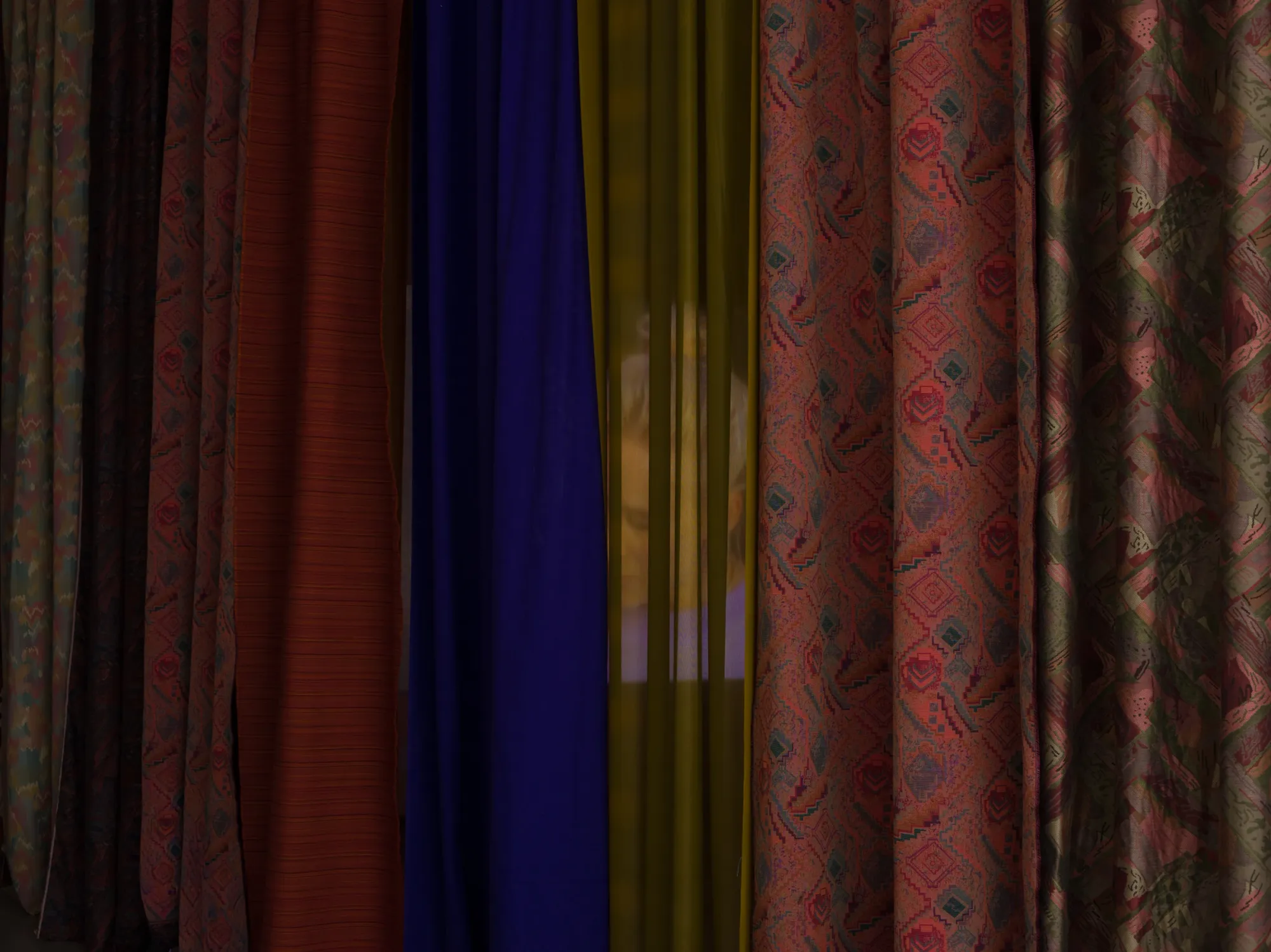 Laurynas Skeisgiela, Liump! Fitness?, Vartai Gallery, Vilnius, 2026, detail of layered mixed-pattern fabric curtains in burgundy, blue, teal and red
