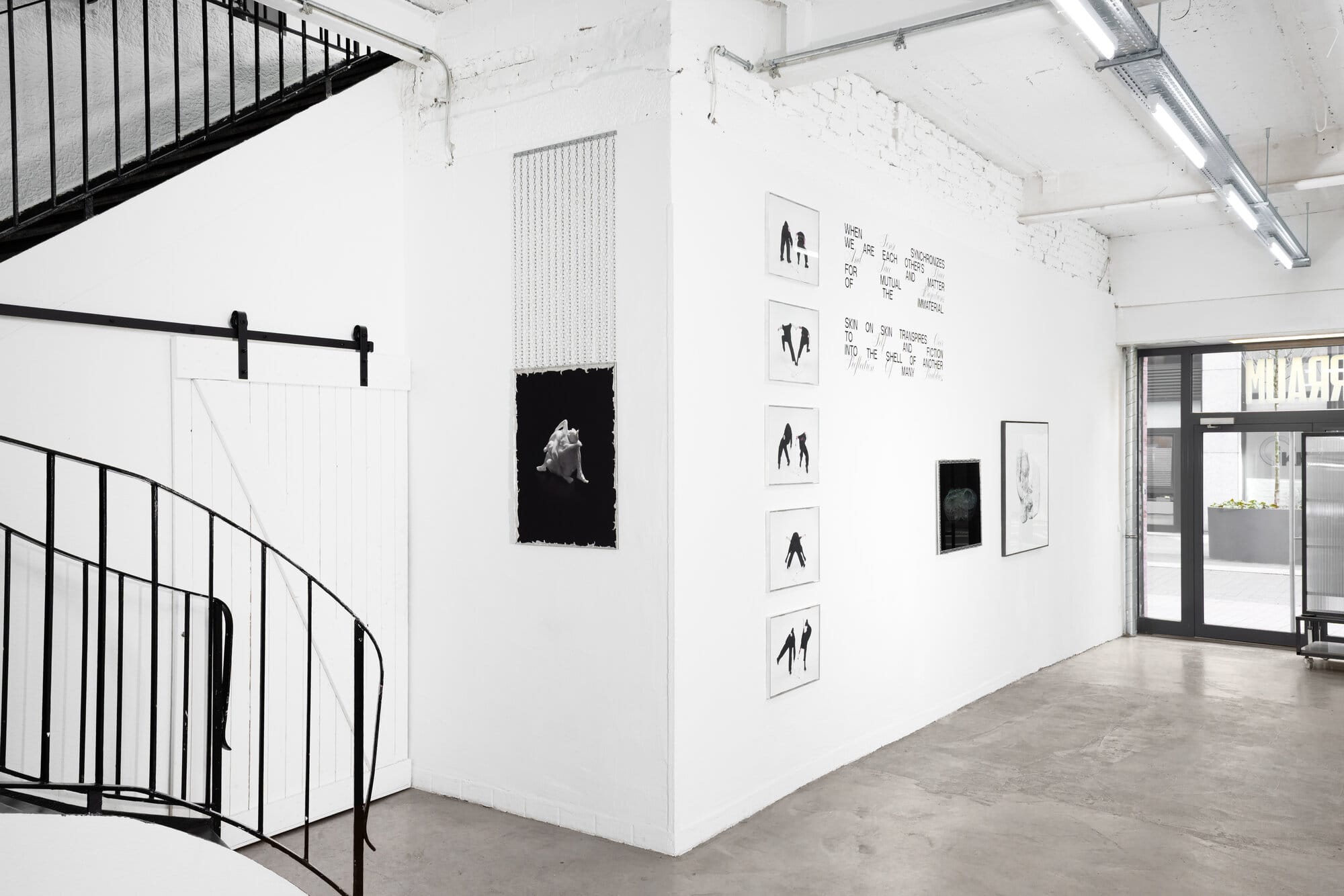 Wide installation view of Call Me We by lom-of-LaMa at SUPERRAUM Dortmund showing all works across the main gallery space including sculpture, wall text, photographic series, and photogrammetry print, 2026