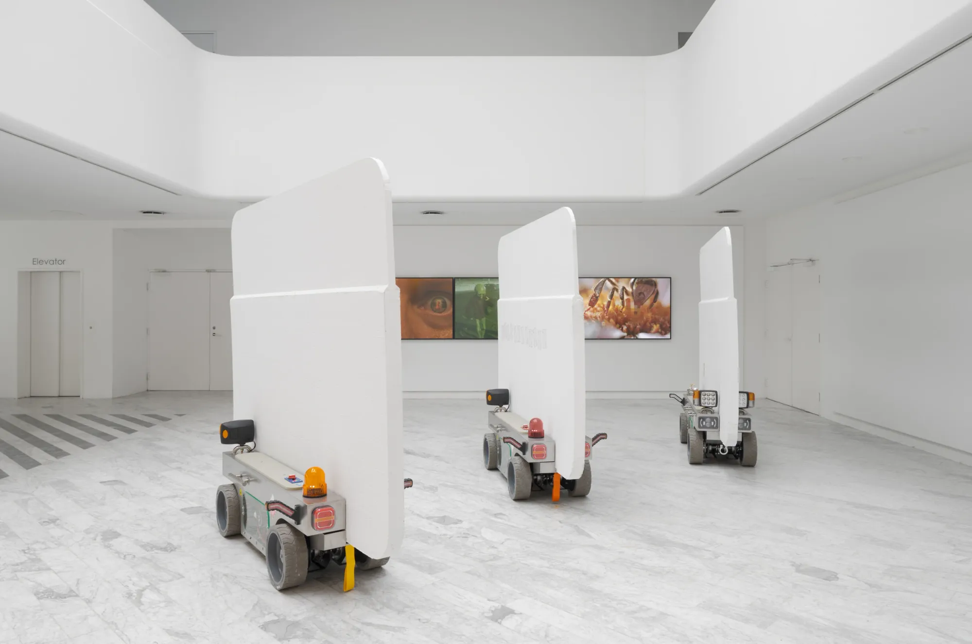 Louis Morlæ, Walls at the World's End, Tranen, Hellerup, 2026, three robotic walls with AI-generated film triptych visible on rear wall