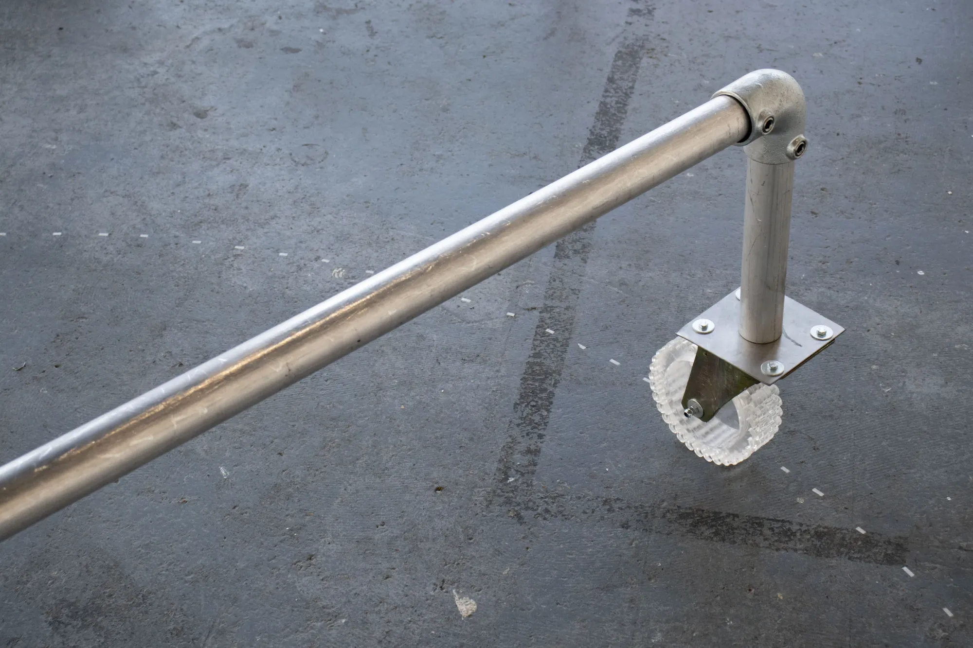 Min Jeong Park, Wheeled Bench, scaffolding pipe and chalk wheel, detail view, 2025
