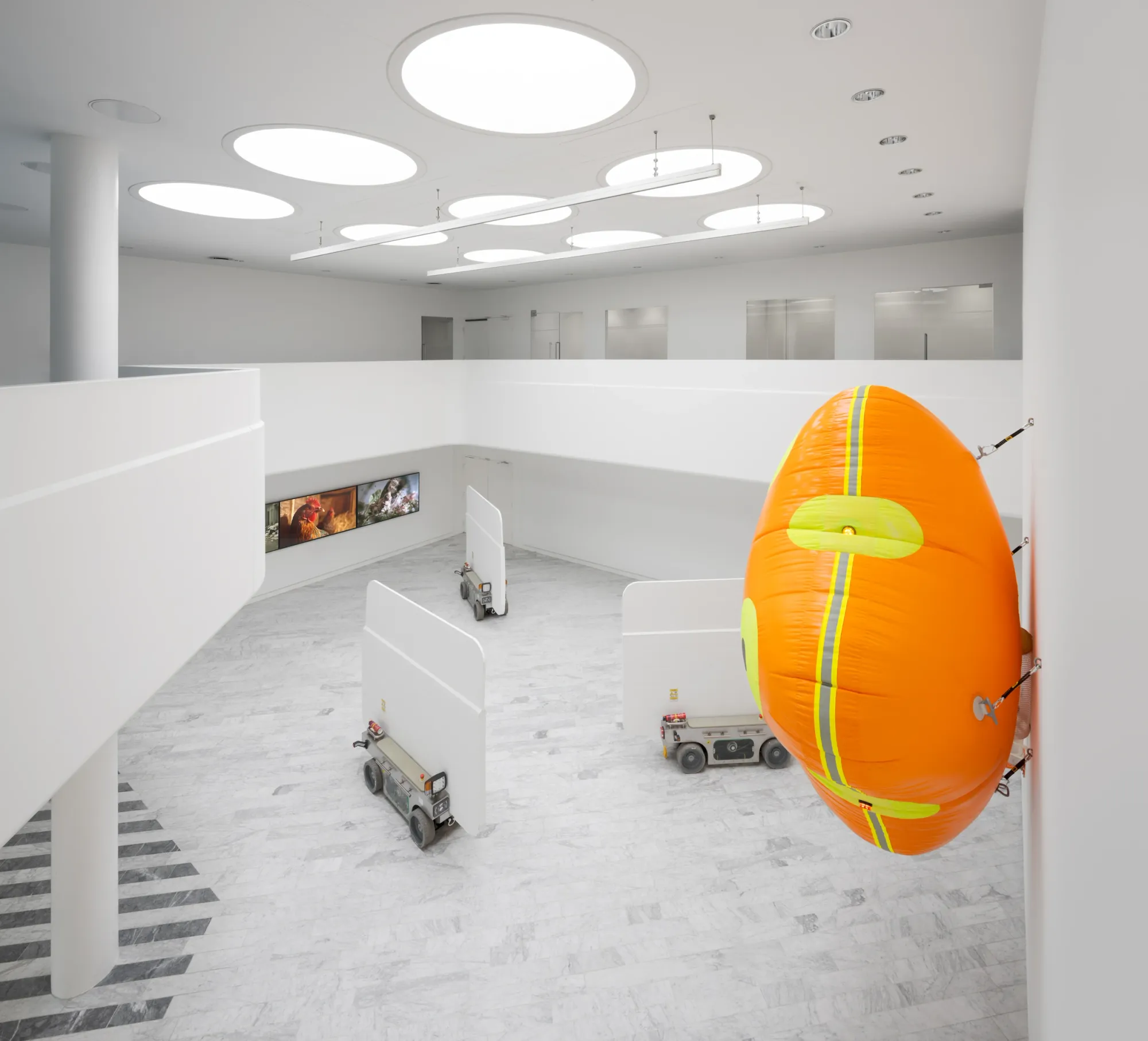 Louis Morlæ, Walls at the World's End, Tranen, Hellerup, 2026, overhead view of robotic walls and orange airbag from upper level