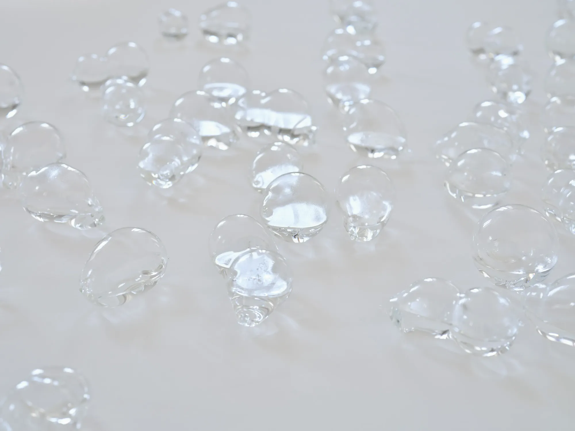 Rahel Oberhummer, Plaine Morte, detail of borosilicate glass bubbles on white surface, irregular organic forms, Montreux, 2026