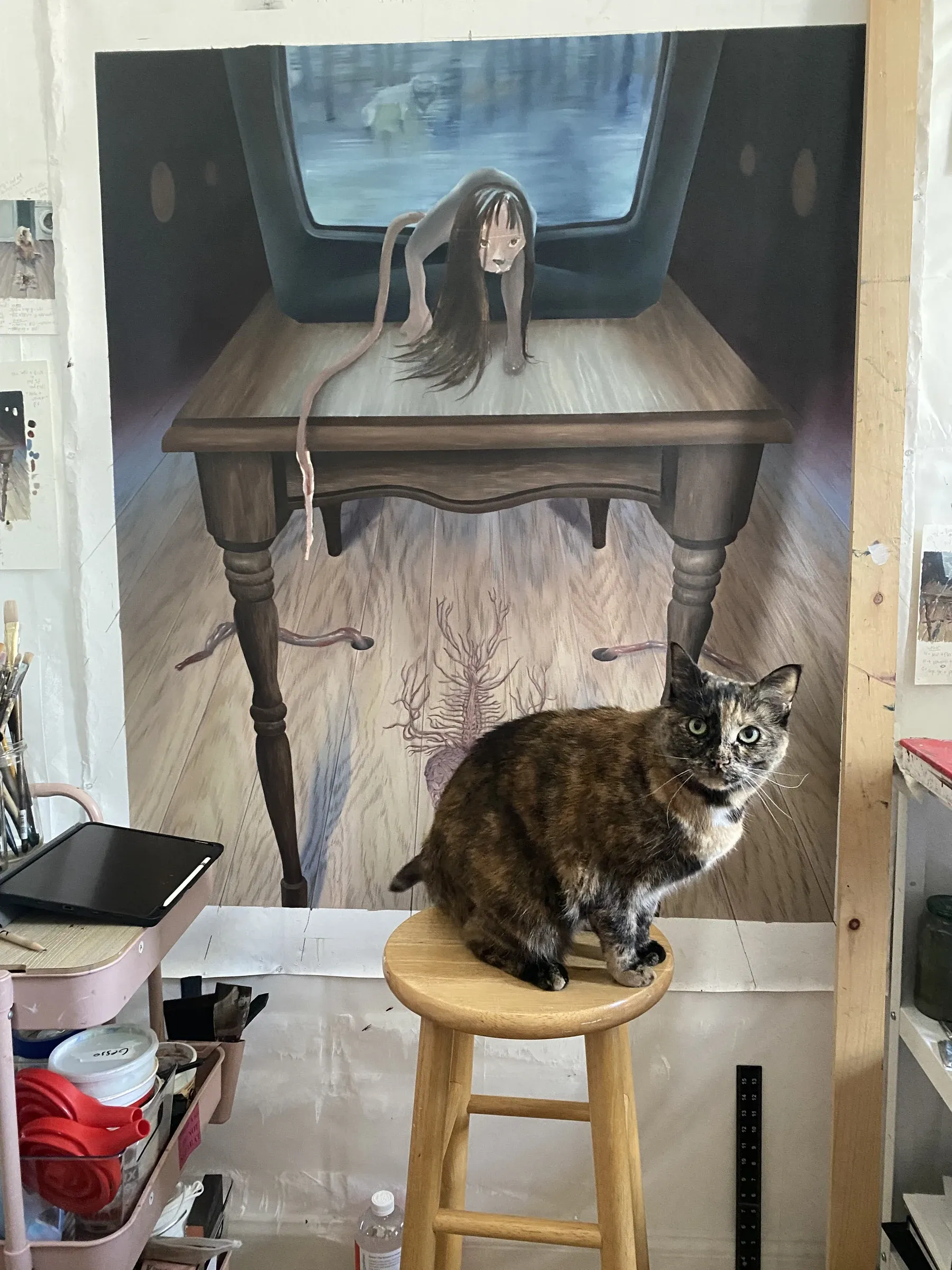 Rei Xiao studio Brooklyn 2025, live cat on stool next to large canvas with painted cat figure in progress