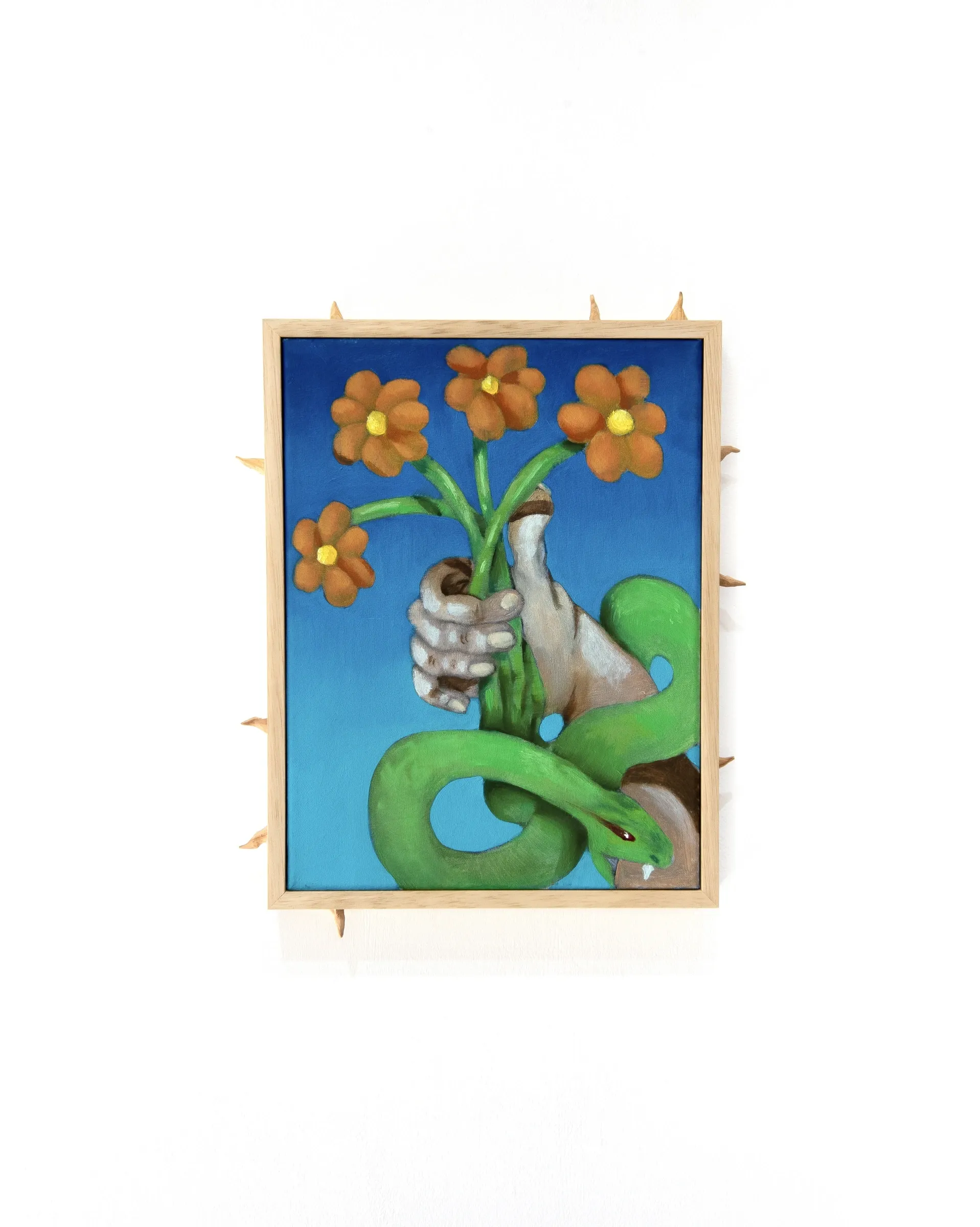 Yeti, Another Divine Sign, 2026, painting of hand holding orange flowers with green snake coiling around arm in spiked wood frame, The Edit Gallery, Limassol