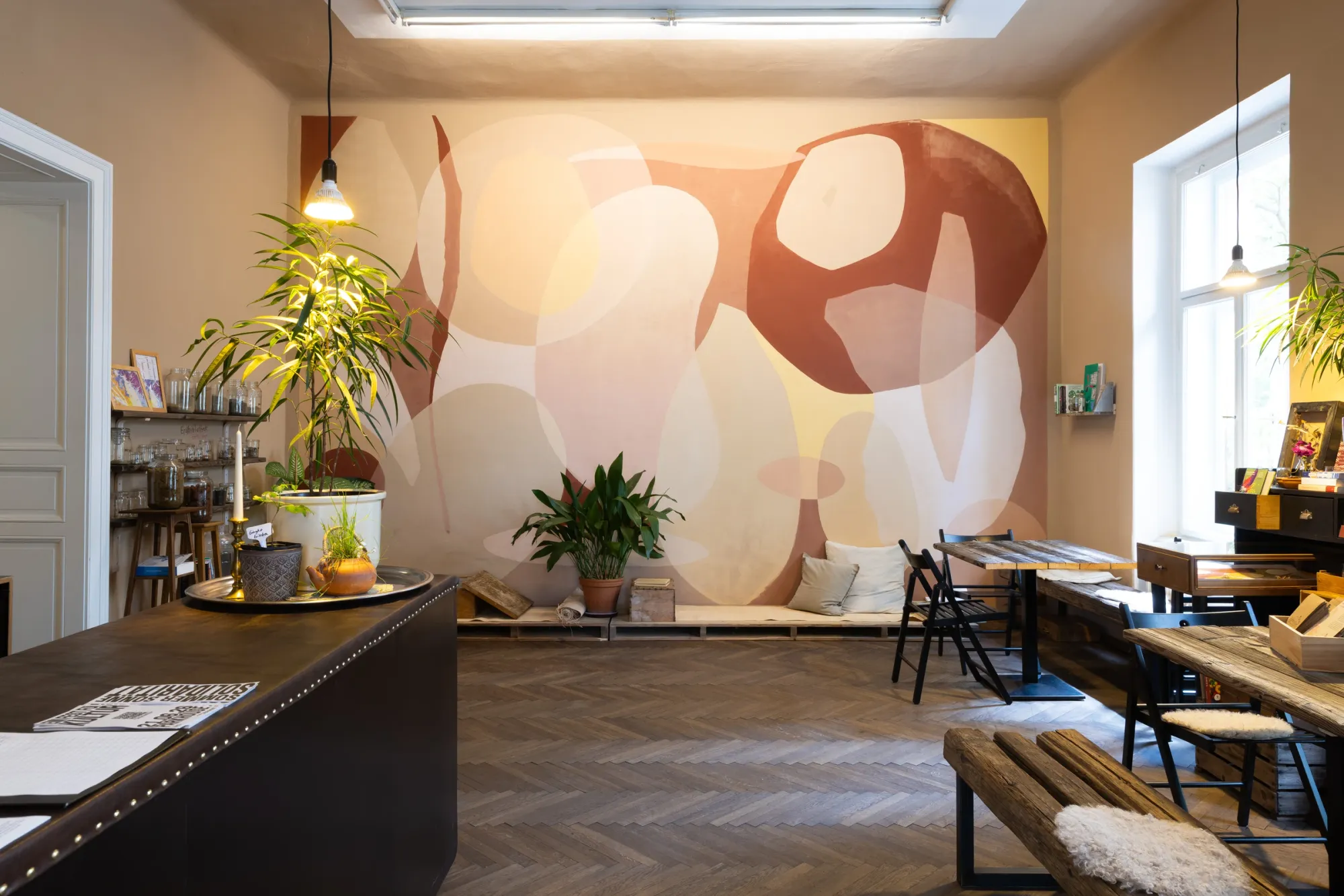AYOCOTL Seed Library, A Parable for Endings and Beginnings, rotor, Graz, 2026, cafe room with Florian Perl mural and plants