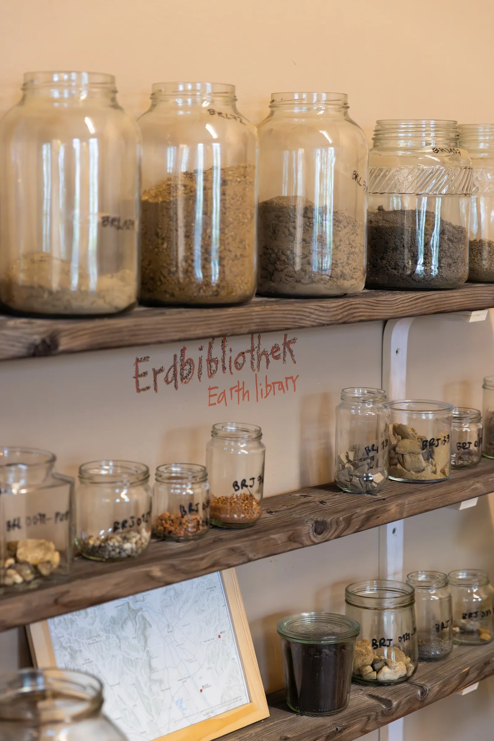 AYOCOTL Seed Library, A Parable for Endings and Beginnings, rotor, Graz, 2026, labelled soil sample jars on wooden shelves