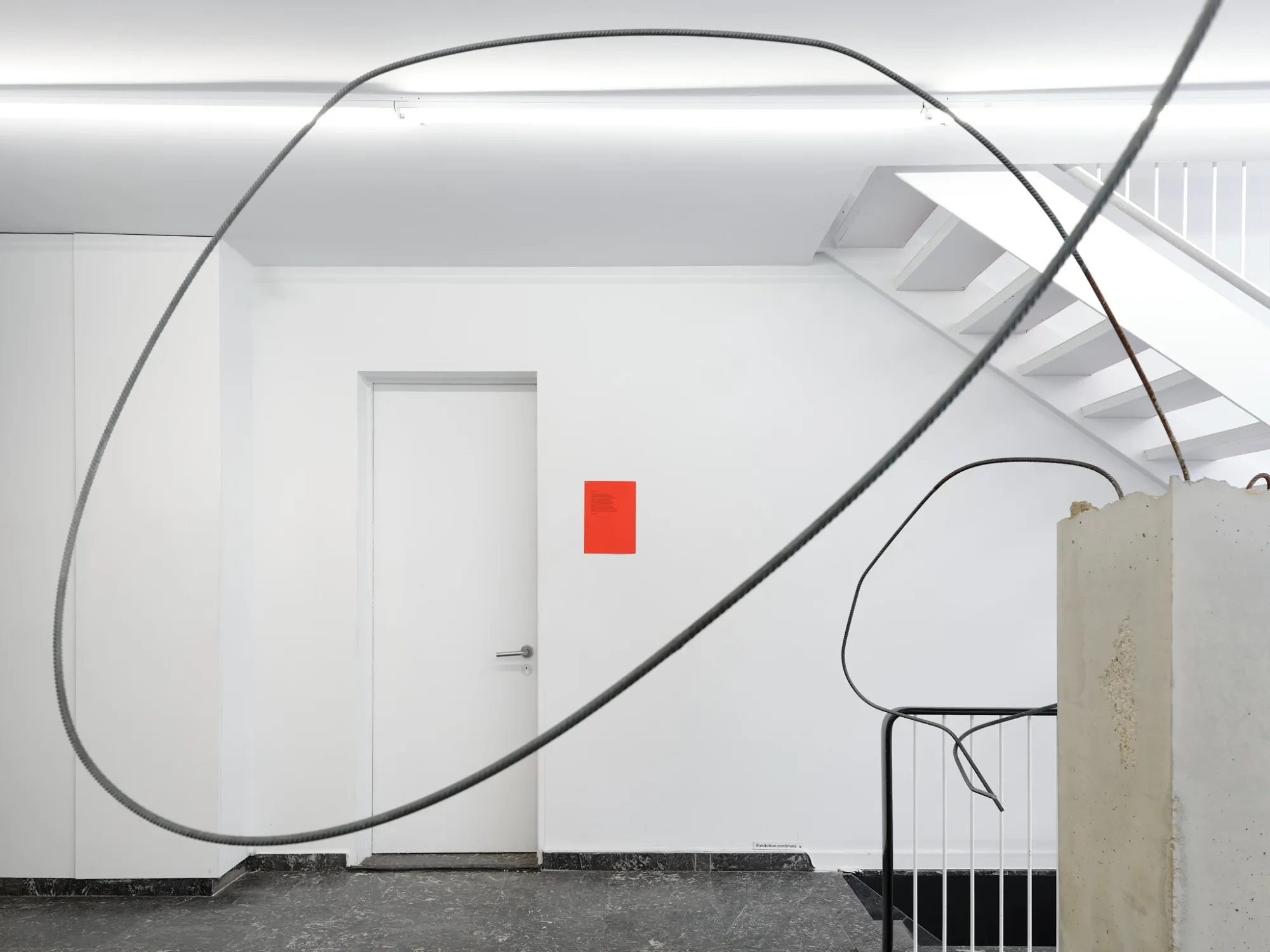 Hannah Perry, Hard Love, Tick Tack, Antwerp, 2026, bent rebar sculpture beside a red wall text panel near a doorway