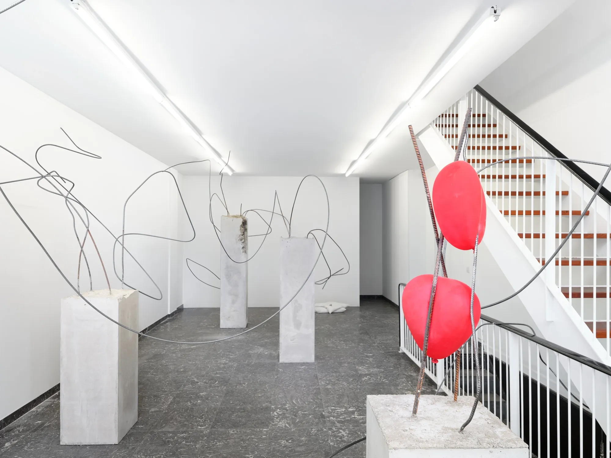 Hannah Perry, Hard Love, Tick Tack, Antwerp, 2026, room with concrete plinths, bent rebar and red balloon-shaped forms