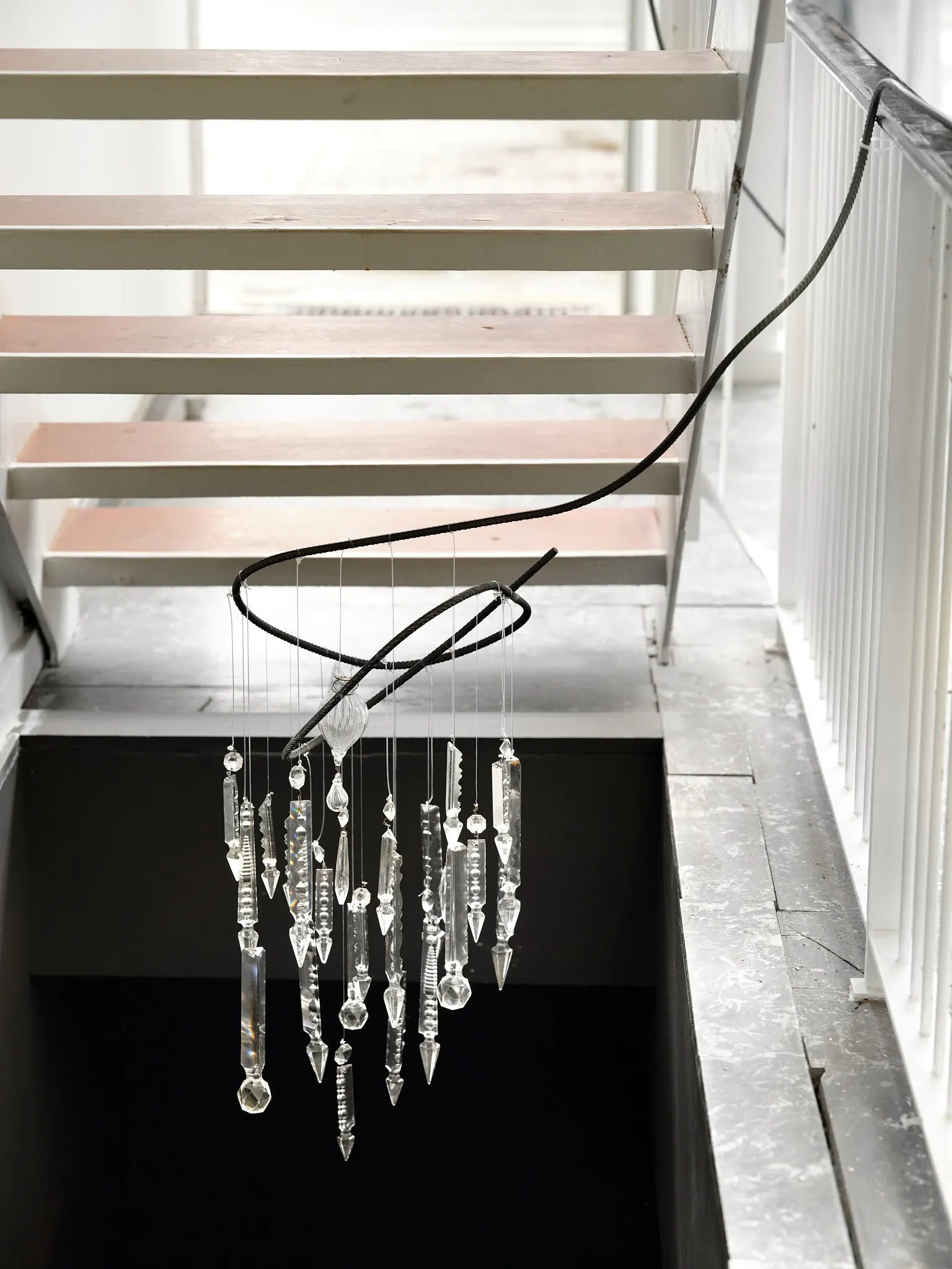 Hannah Perry, Hard Love, Tick Tack, Antwerp, 2026, hanging sculpture of rebar and cut glass pendants above a staircase
