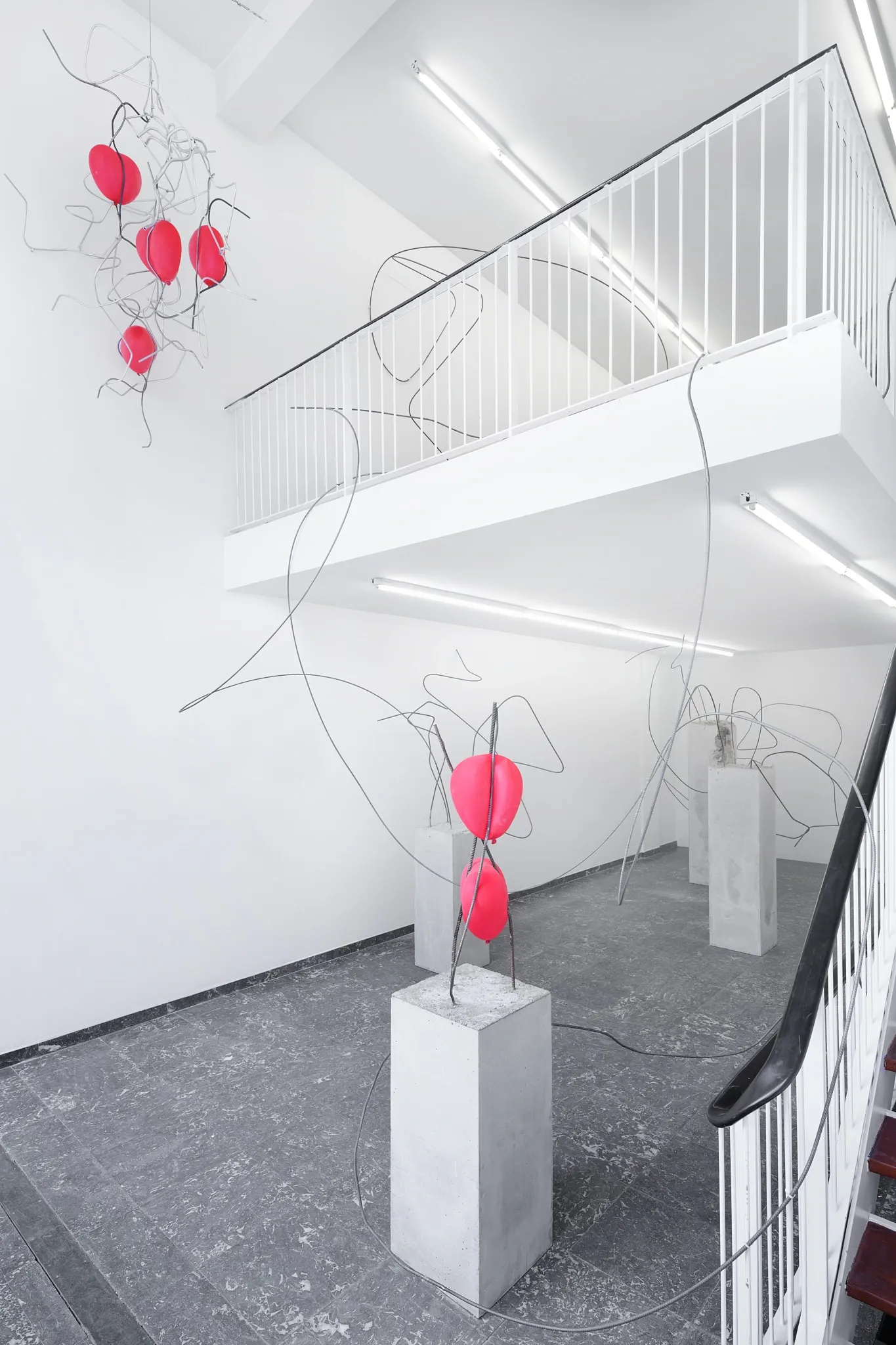 Hannah Perry, Hard Love, Tick Tack, Antwerp, 2026, concrete plinth with looping rebar and a soft white form on the floor