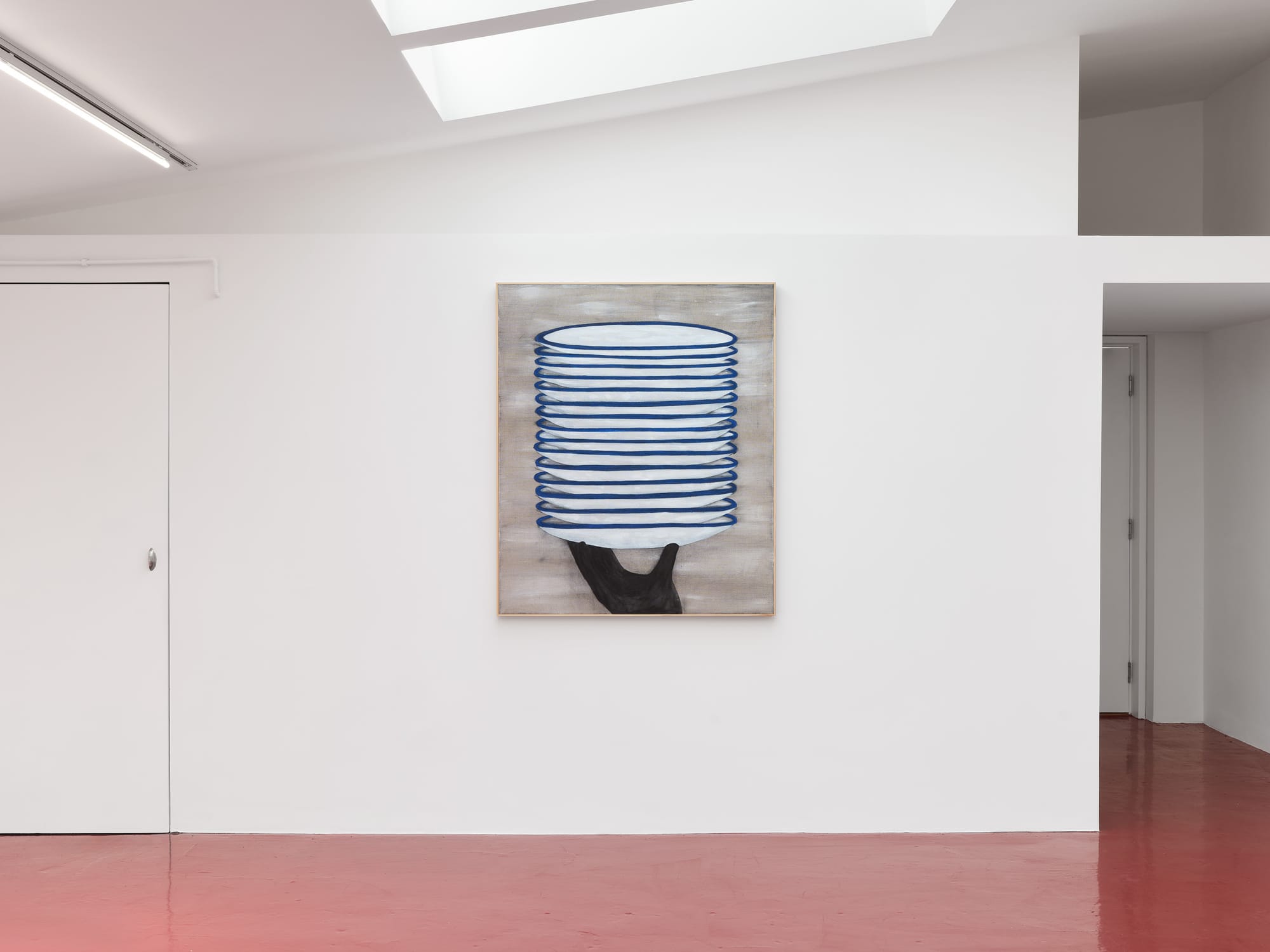 Ethan Caflisch artwork- Exhibition review of What Shall We Do for the Rent? at Haricot Gallery, London, 2026. A stack of white plates with blue rims balanced on an outstretched black arm against a grey ground.