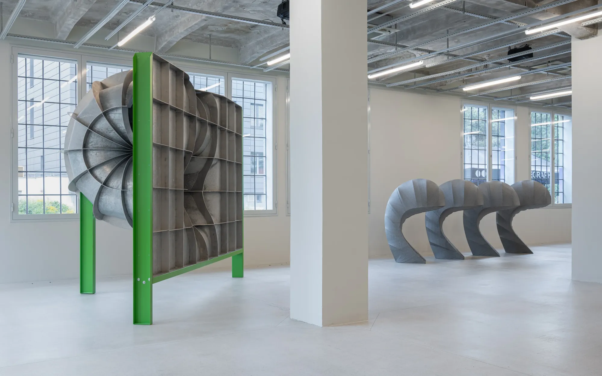 Exhibition review of Jiří Příhoda: Signal V at Telegraph Gallery, Olomouc, 2026. Metal panel construction seen from behind beside bowed fabric sculptures.