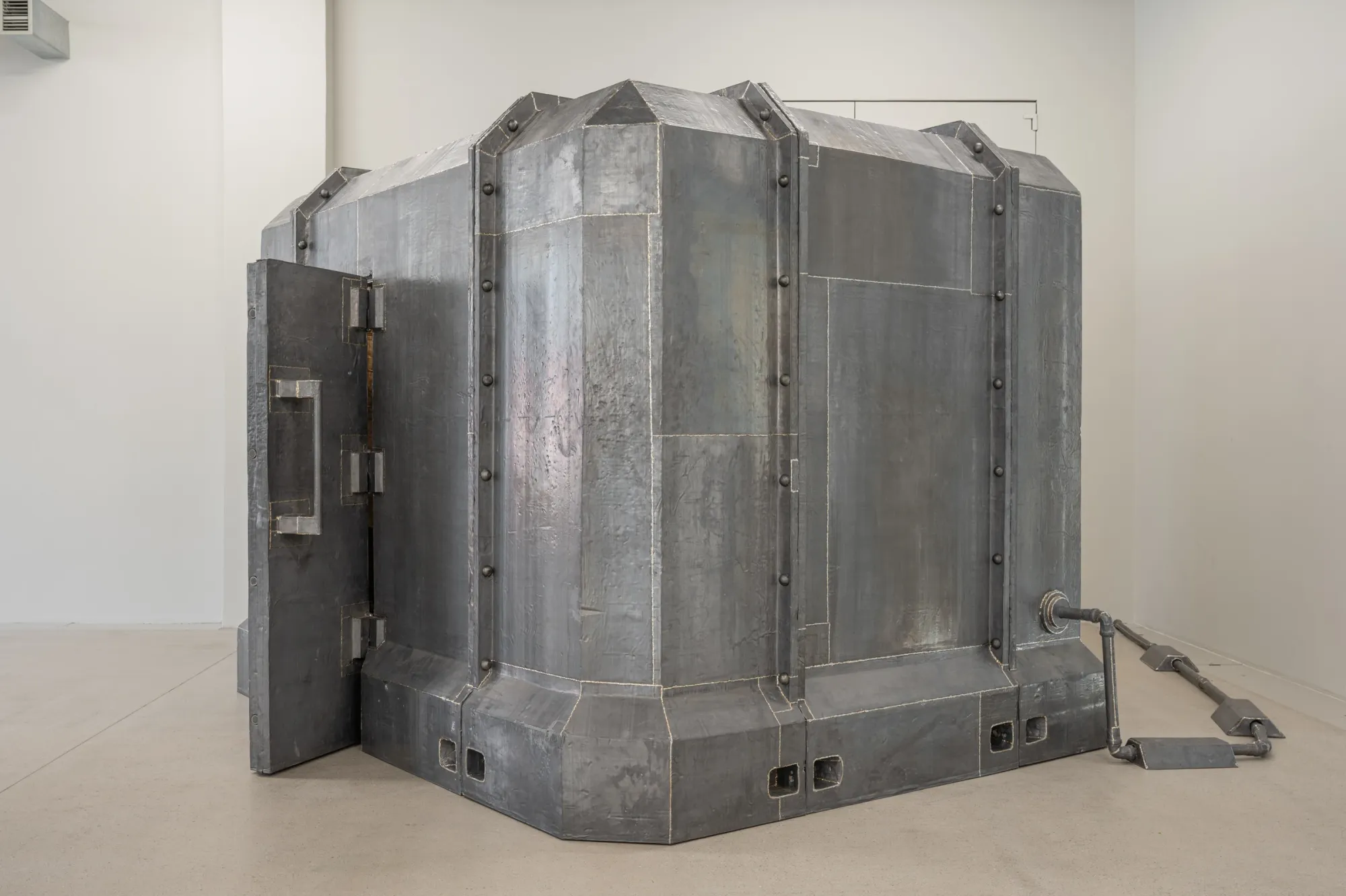 Exhibition review of Krištof Kintera: Signal V at Telegraph Gallery, Olomouc, 2026. Close view of a riveted galvanized steel vault with exposed weld seams.