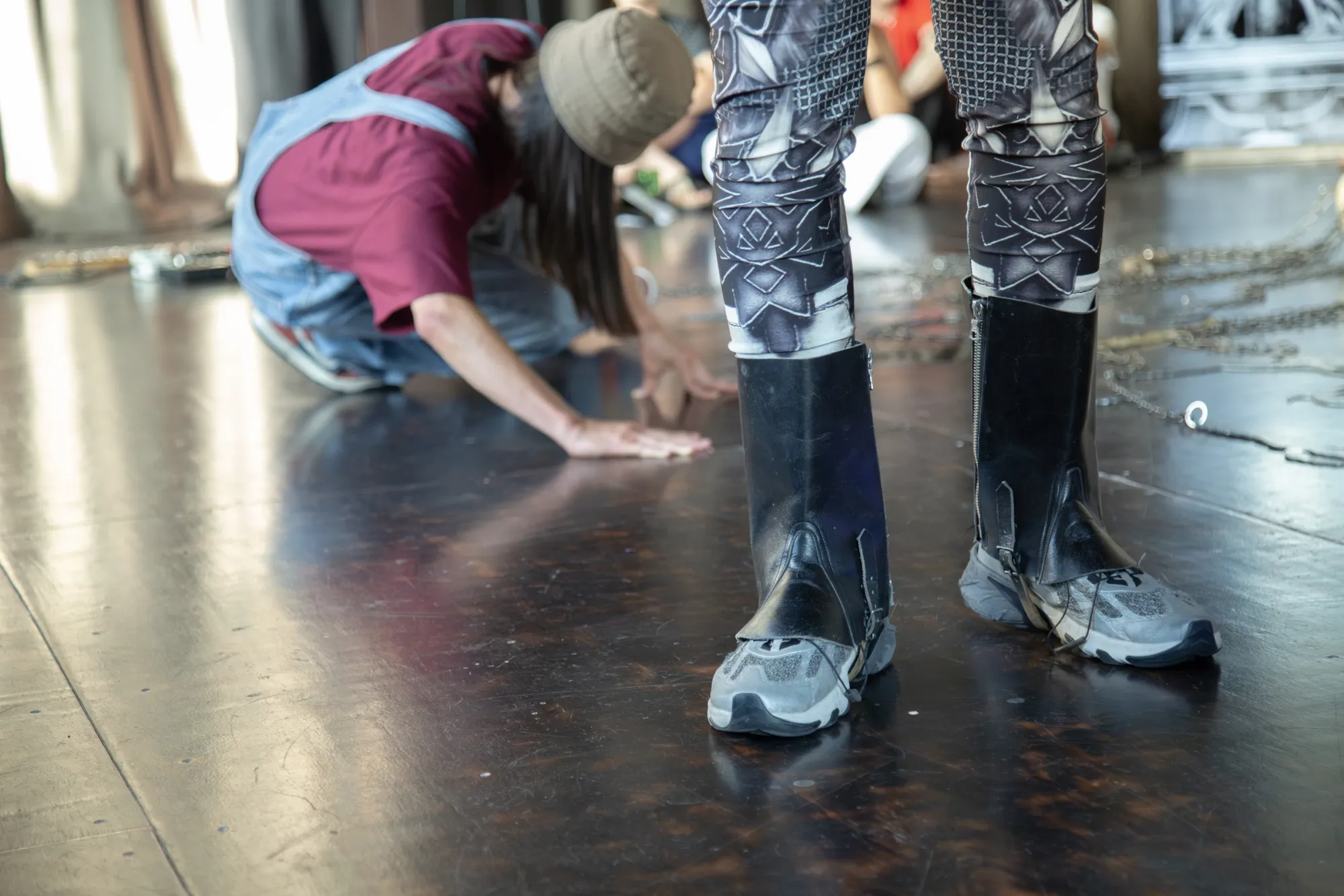 Nicola Genovese, Infinite Stage, detail, performer's patterned leggings and boots on the stage floor, Raleigh Chapel, 2026