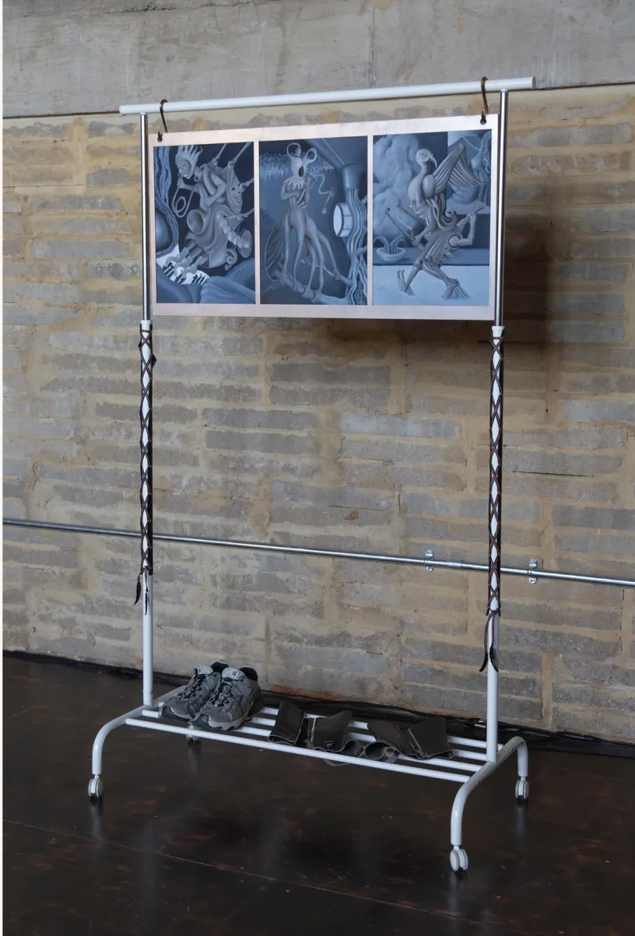 Nicola Genovese, Infinite Stage, Raleigh Chapel, London, 2026, painted triptych hung on a garment rack above a pair of shoes